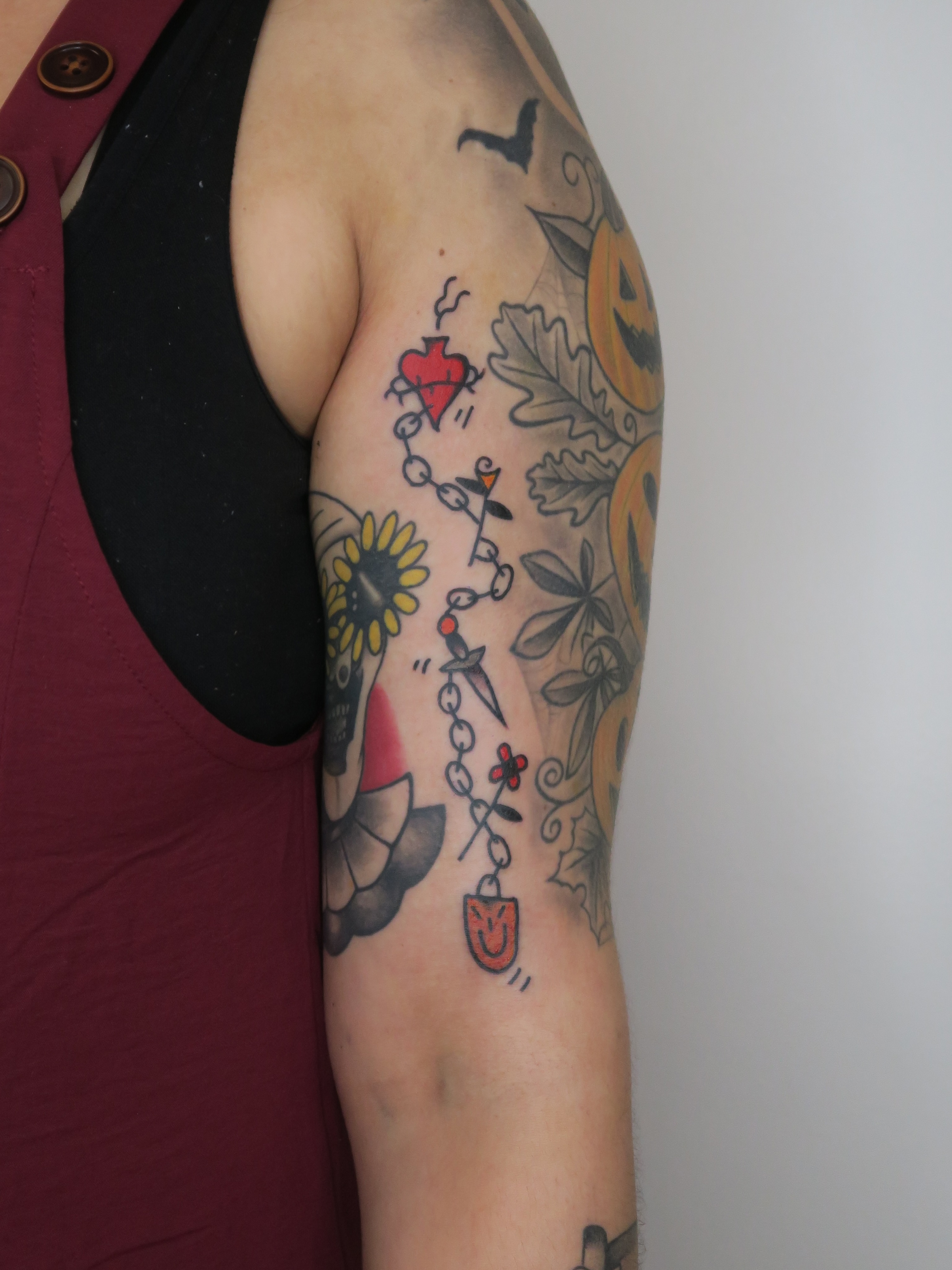 Heart and dagger American traditional tattoo on the upper arm by Roman