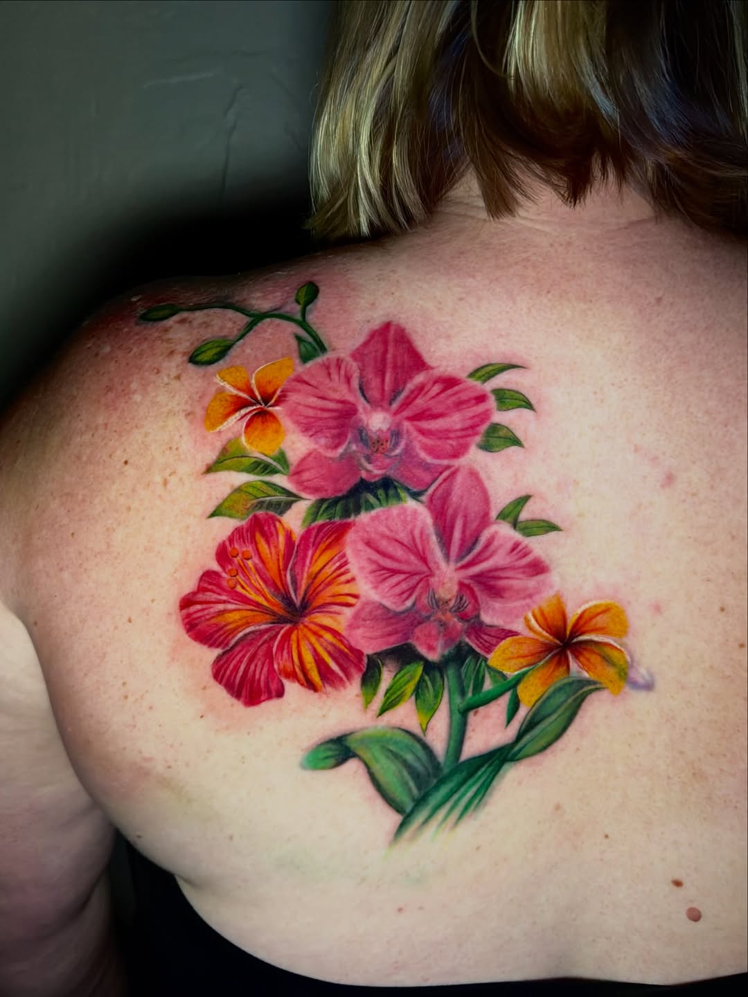 Tropical flowers watercolor tattoo on the shoulder by jayla pantig
