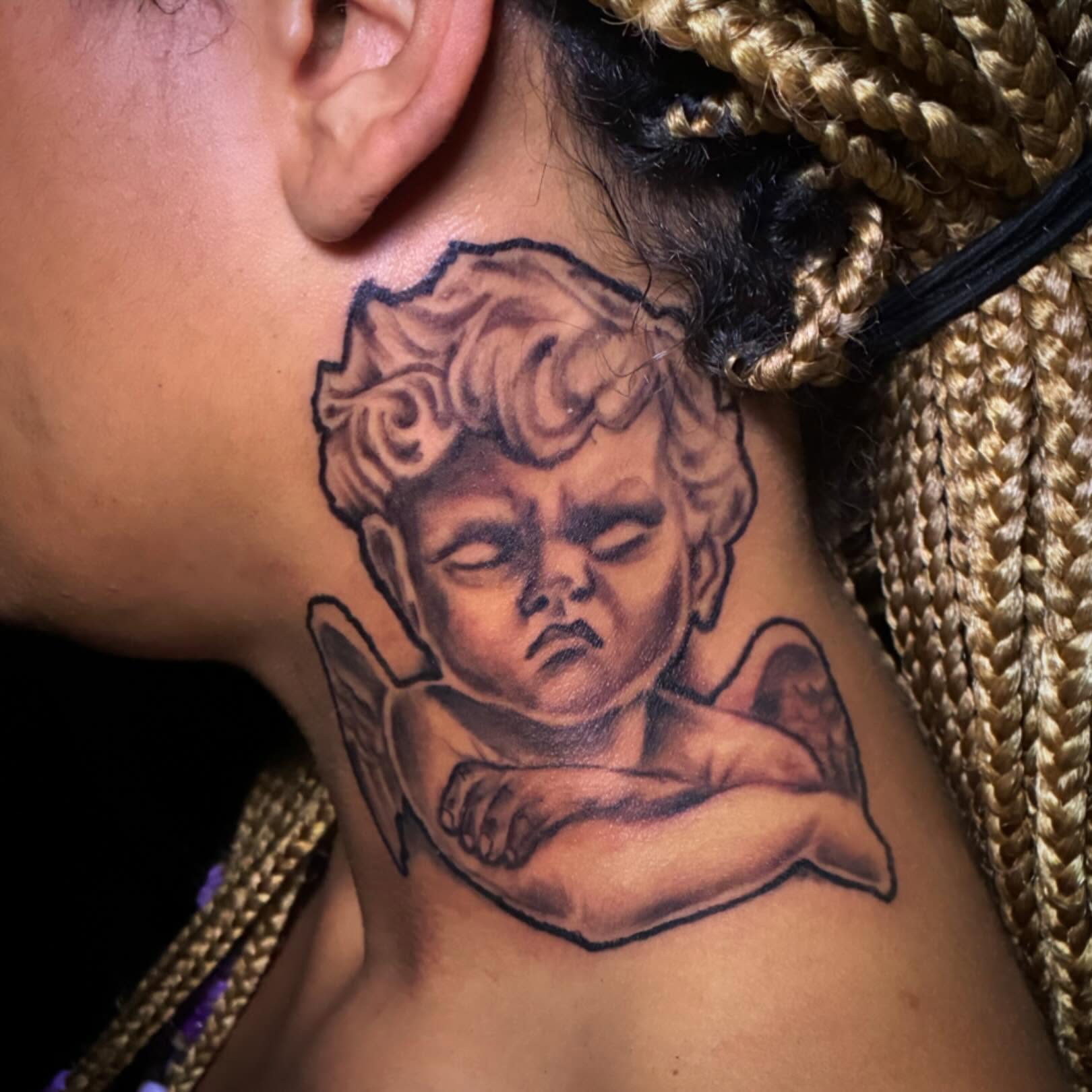 Sleeping cherub realism tattoo on the neck by Darius Armour (Tattoo Artist)