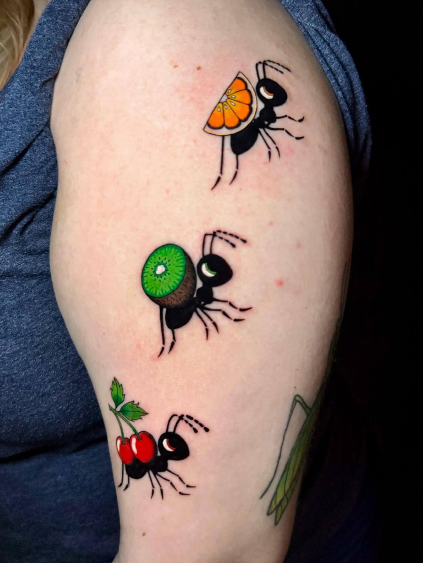 Ants carrying fruit dotwork tattoo on the upper arm by Tess