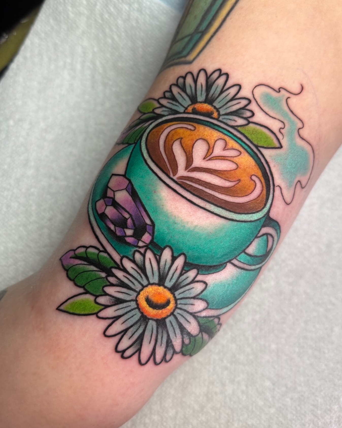 Coffee cup with latte art American traditional tattoo on the forearm by 𝔎𝔦𝔯𝔞 𝔅𝔦𝔰𝔥𝔬𝔭