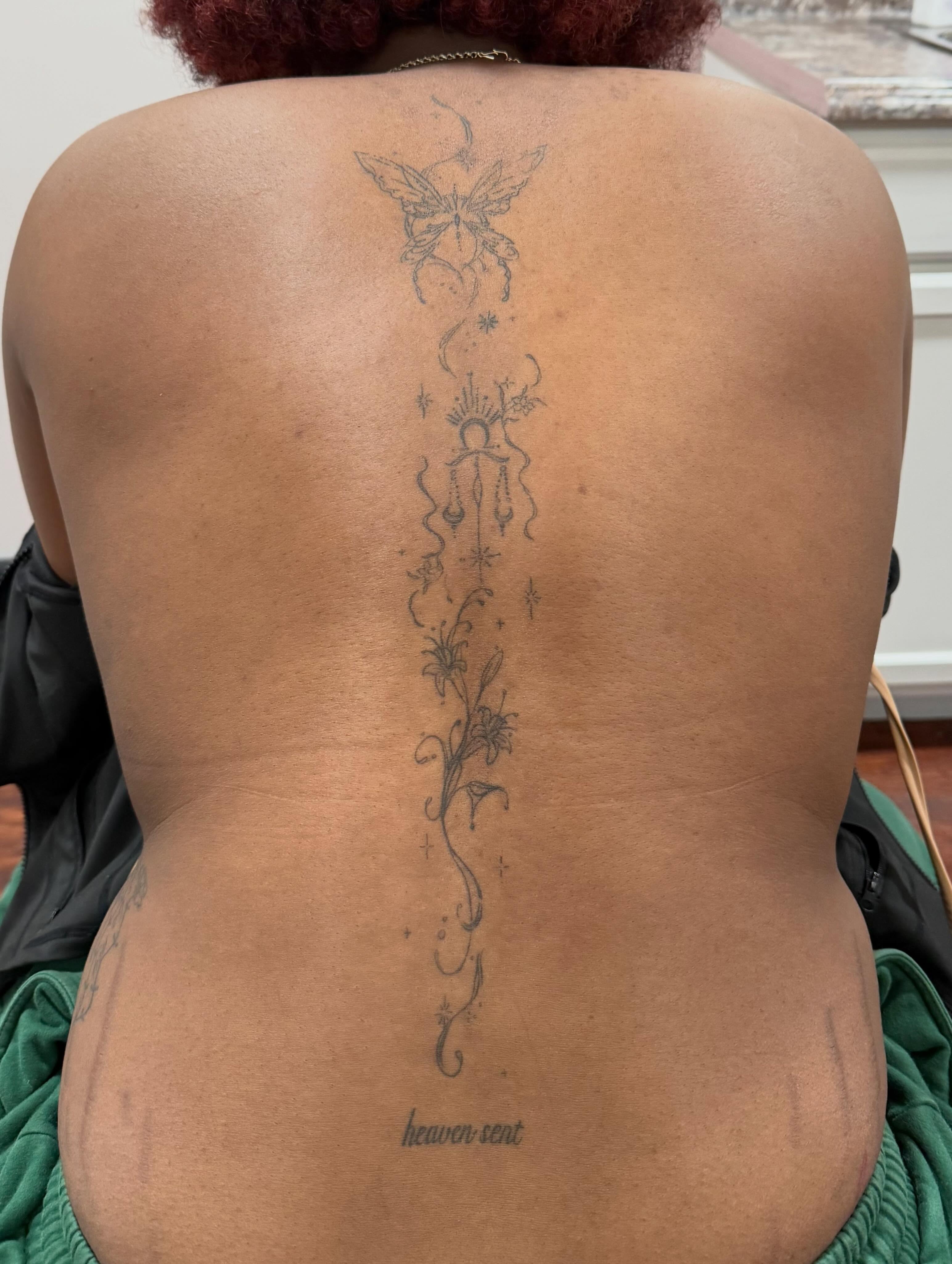 Butterfly and floral fine line tattoo on the back by Lexie Decker, Canton, Ohio