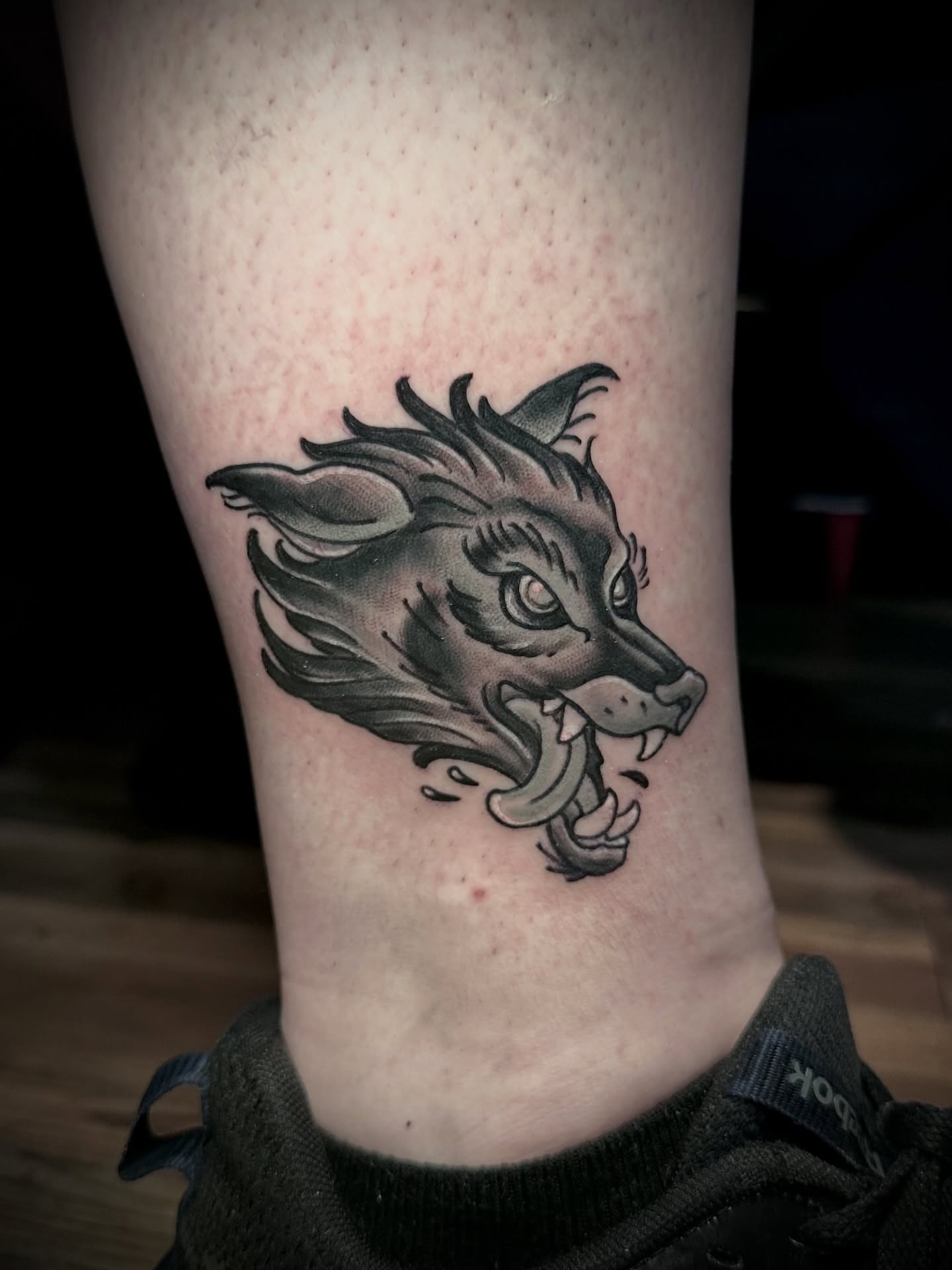 Wolf head black and grey tattoo on the forearm by Teddi Garson