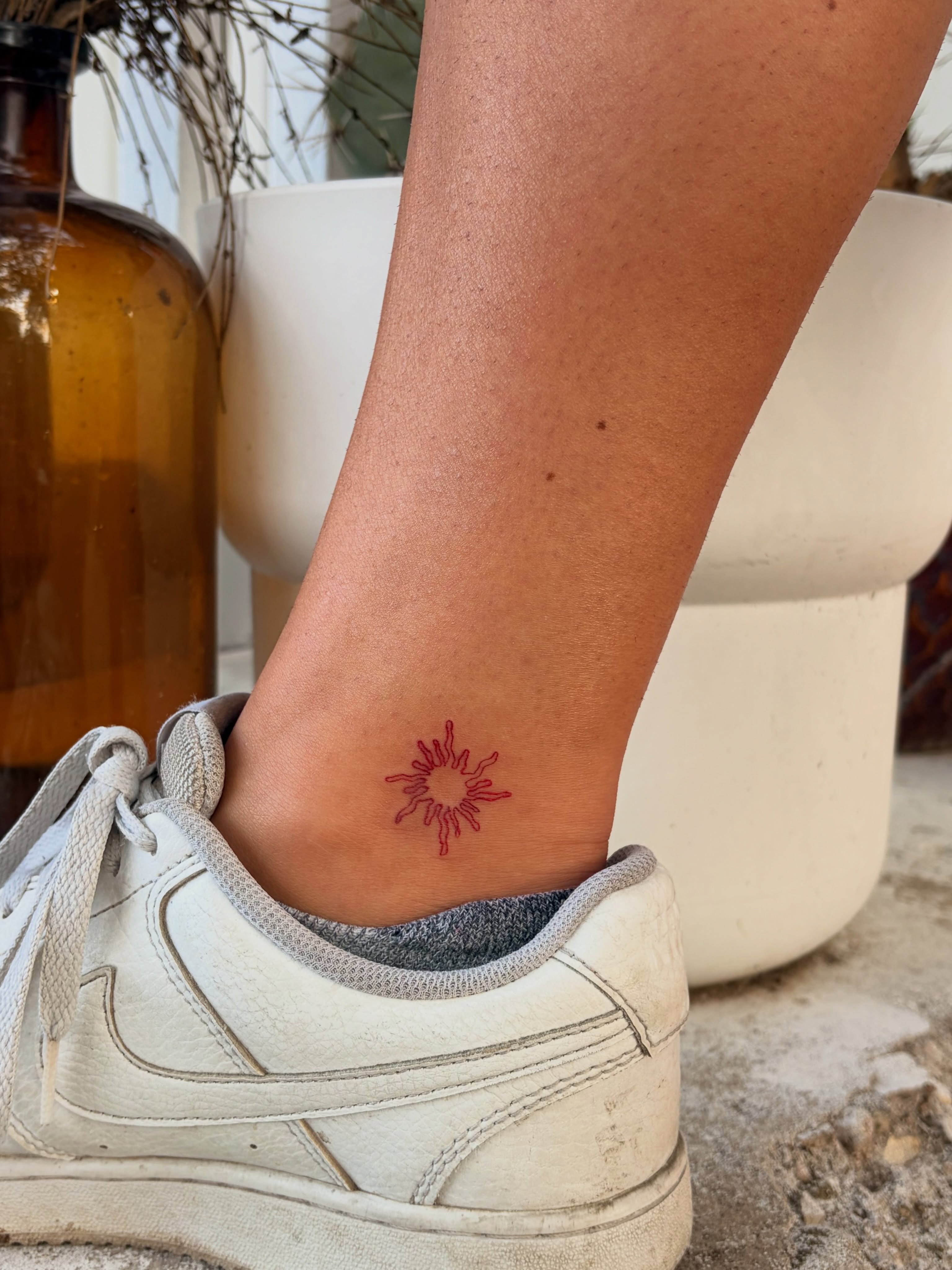 Sunburst geometric tattoo on the calf by Inky Birdz Tattoos