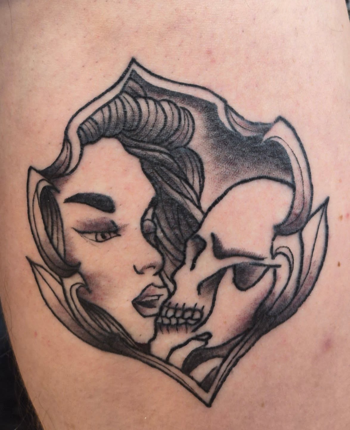 Woman and skull American traditional tattoo on the thigh by Bobby H