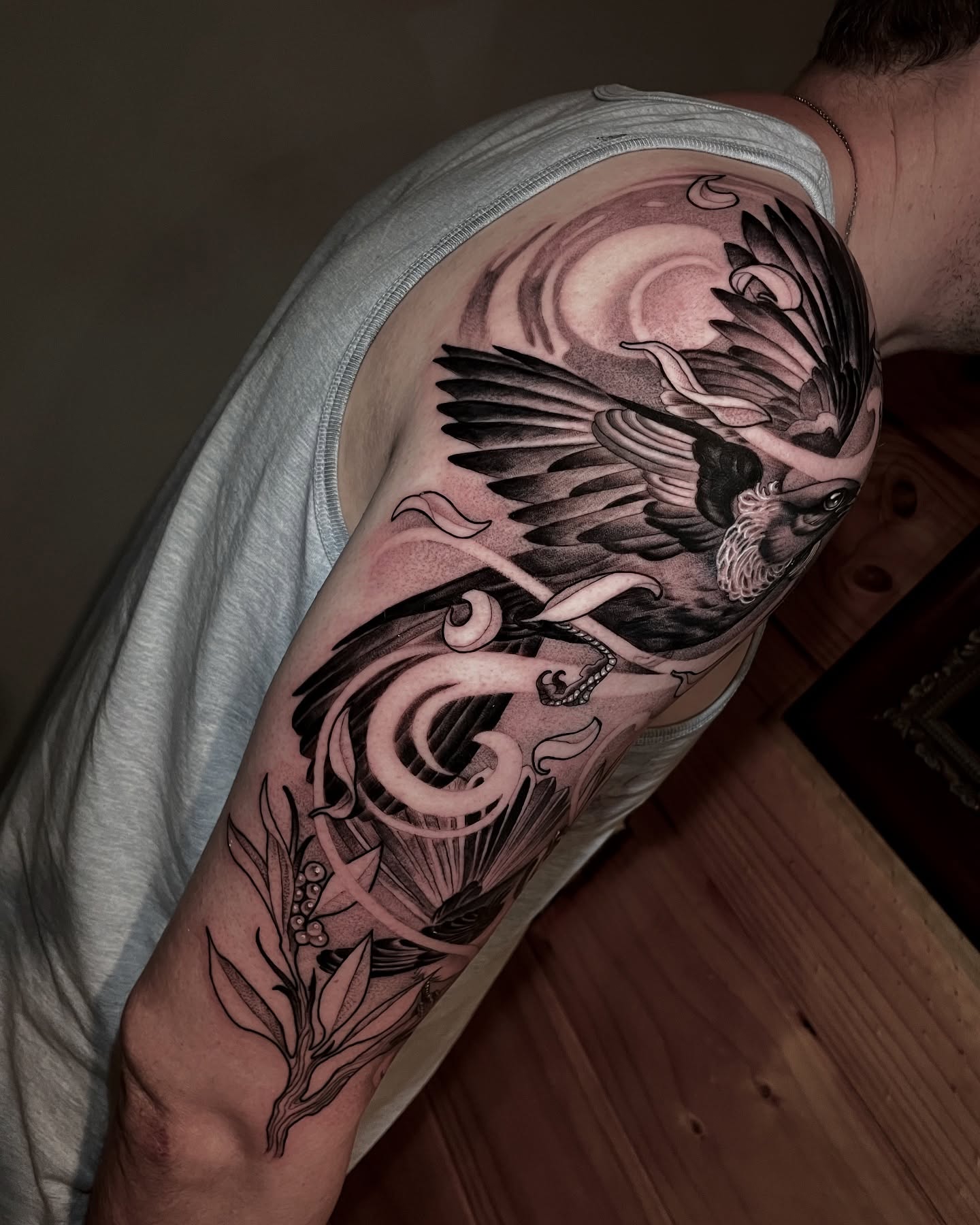 Phoenix black and grey tattoo on the forearm by Michelle Carlton