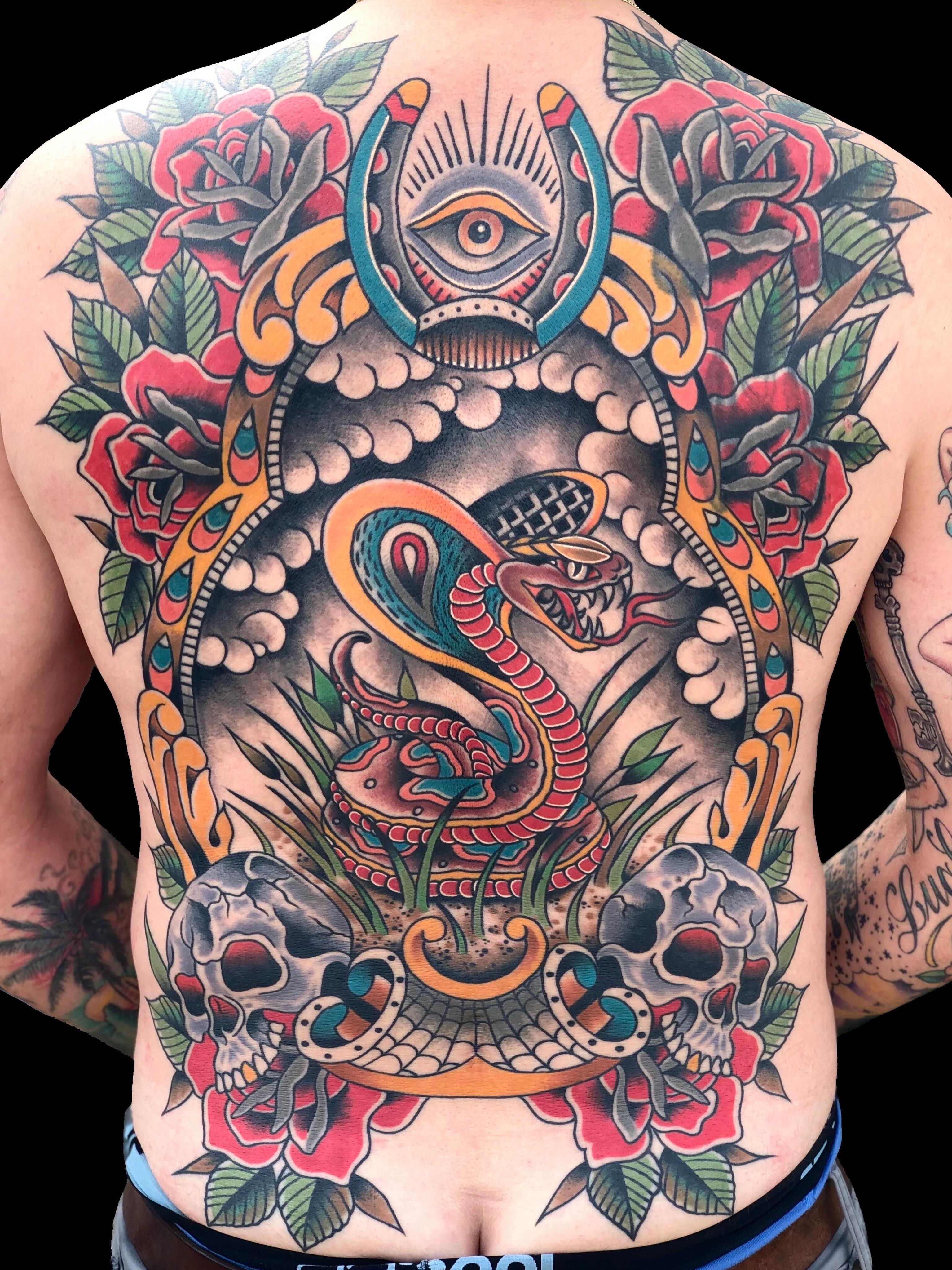 Snake and skull American traditional tattoo on the back by Dave Kruseman