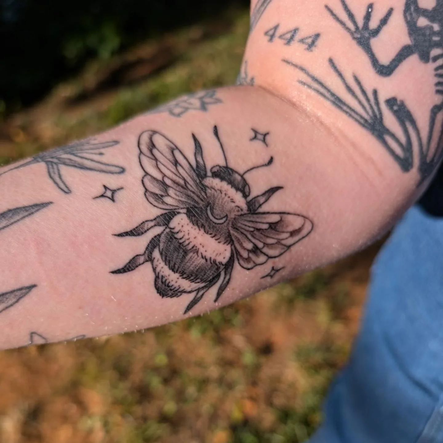 Bee black and grey tattoo on the forearm by Chad Nuber