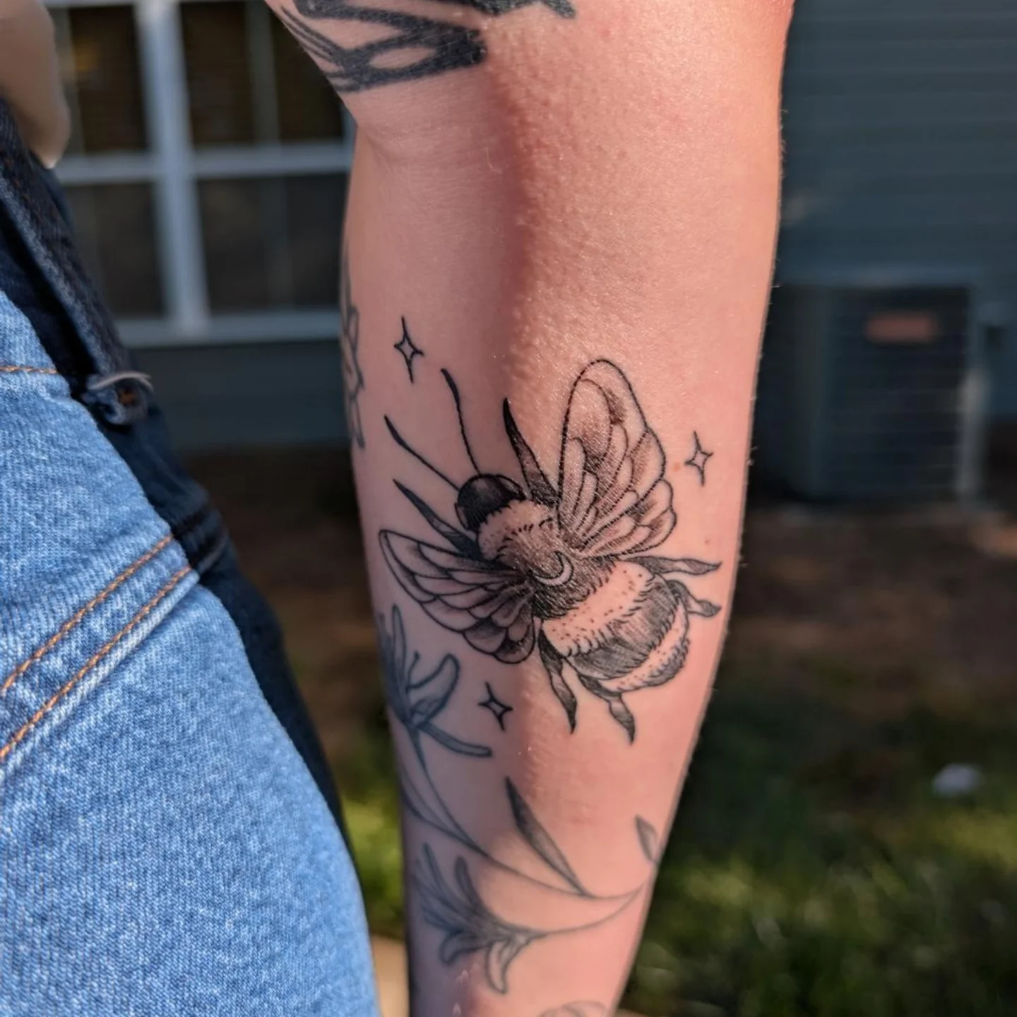Bee black and grey tattoo on the forearm by Chad Nuber