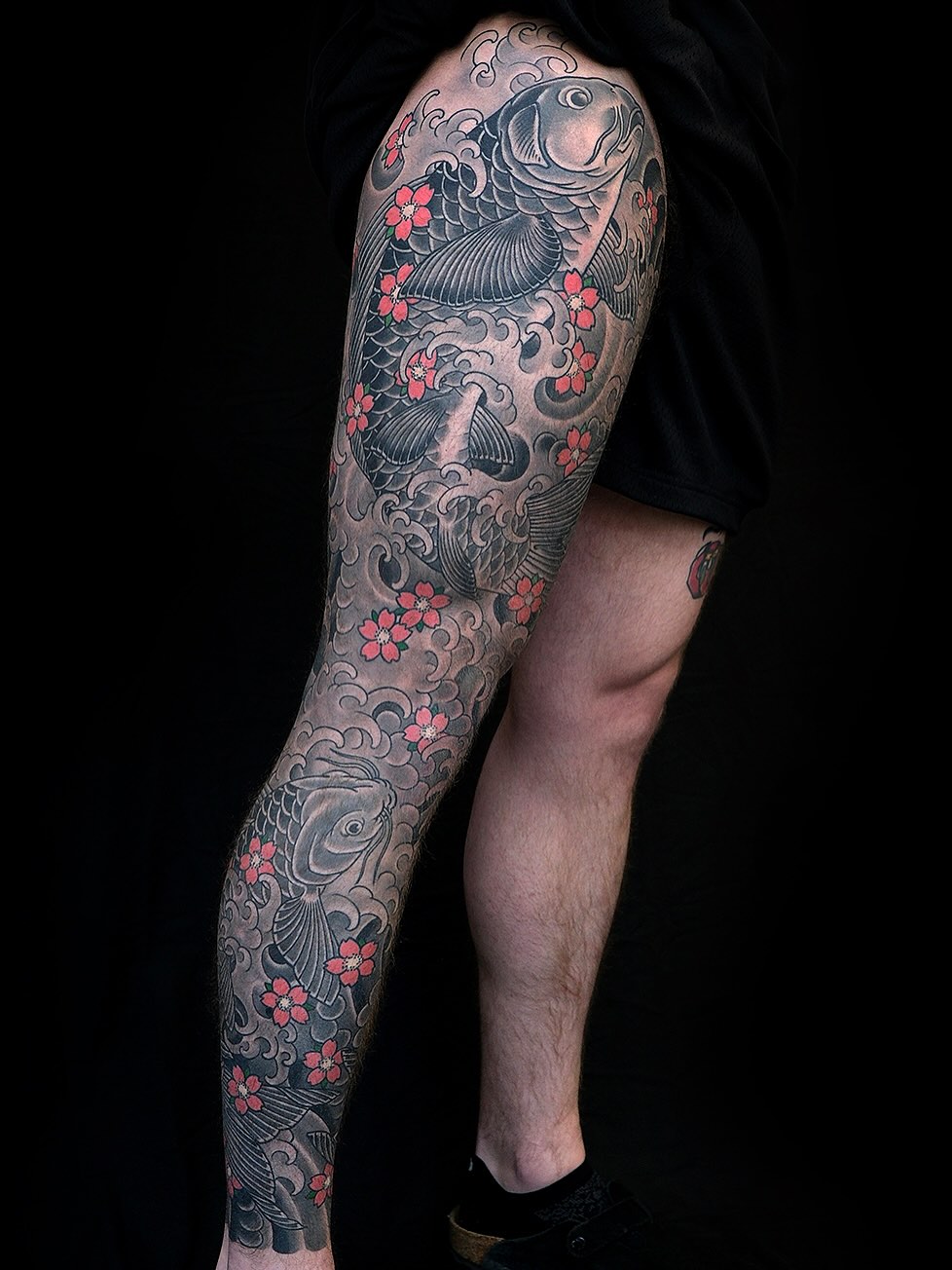 Koi fish and cherry blossoms Japanese tattoo on the thigh by Erick Lynch, Cambridge, Massachusetts