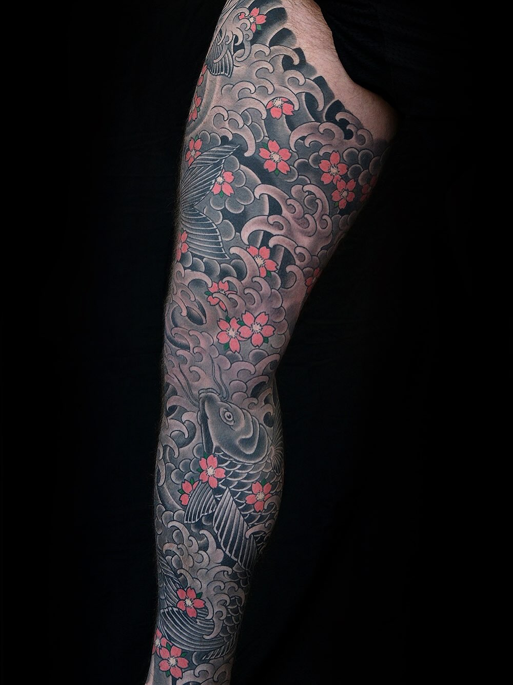 Koi fish and waves Japanese tattoo on the forearm by Erick Lynch, Cambridge, Massachusetts
