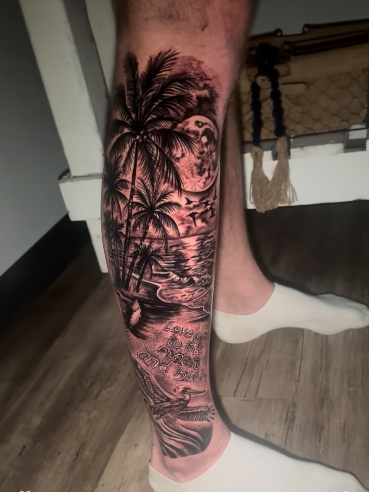 Beach scene realism tattoo on the calf by Tampa tattoo artist