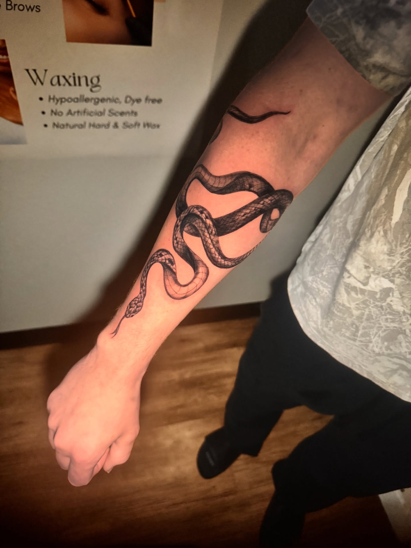 Snake black and grey tattoo on the forearm by Tampa tattoo artist