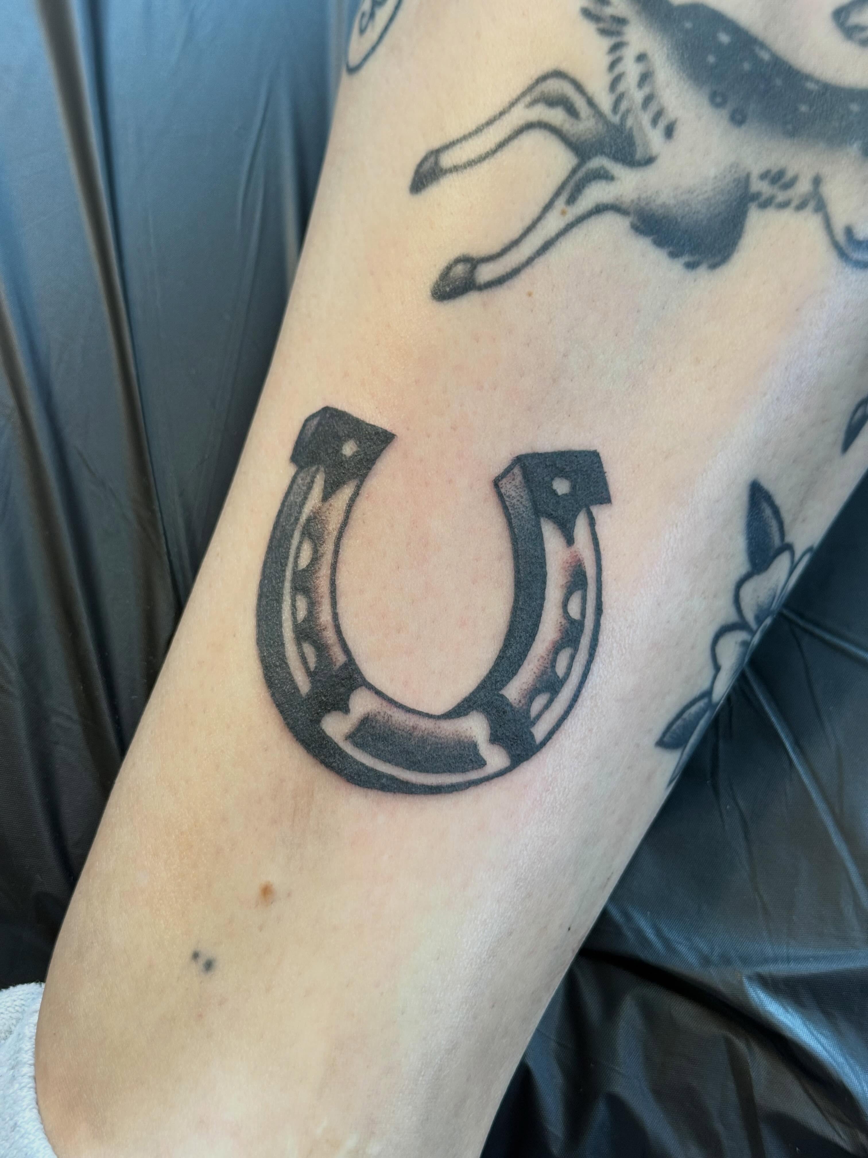 Horseshoe black and grey tattoo on the forearm by Jesse Boss, Nashville, Tennessee