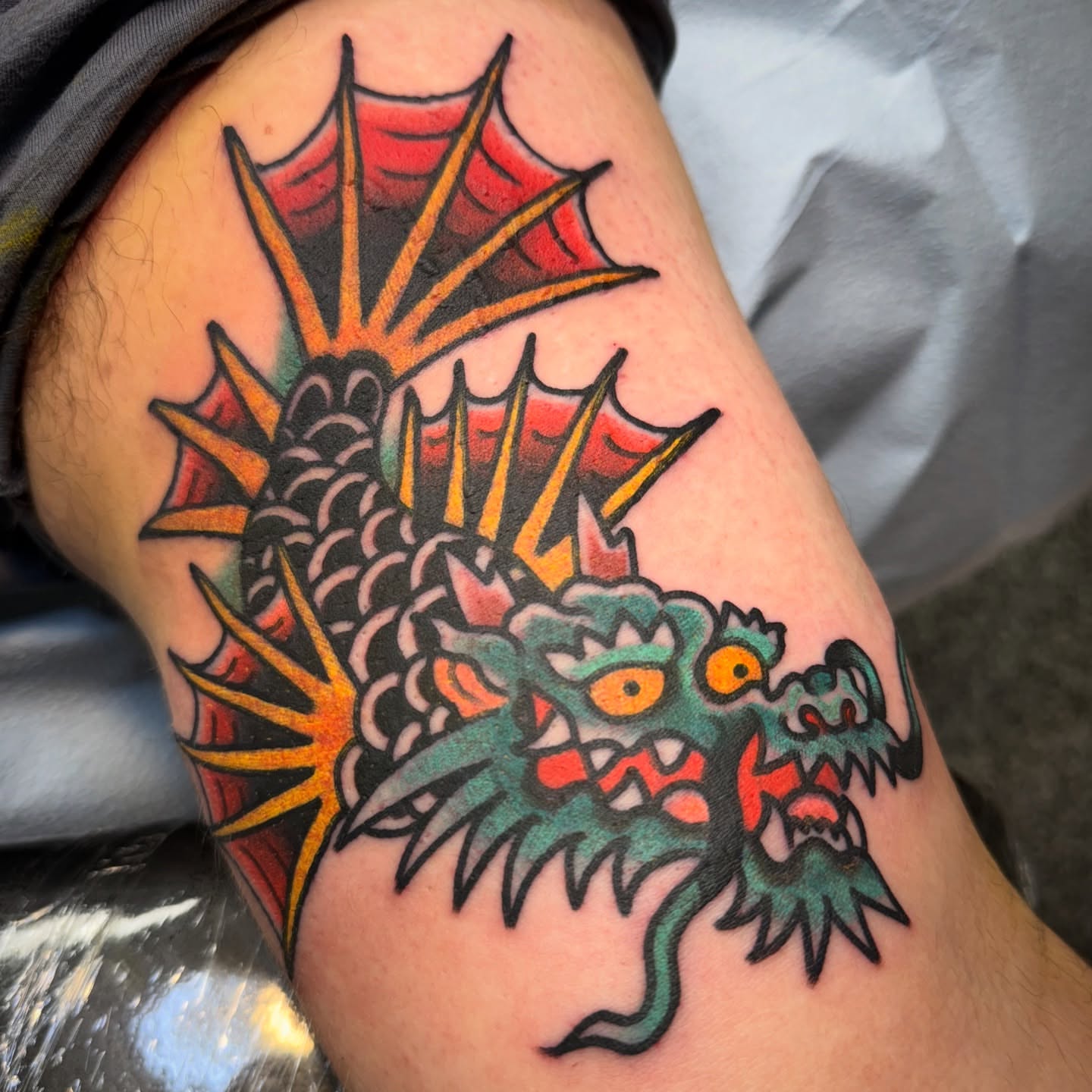 Dragon American traditional tattoo on the thigh by Chuck Paprocki, Nashville, Tennessee