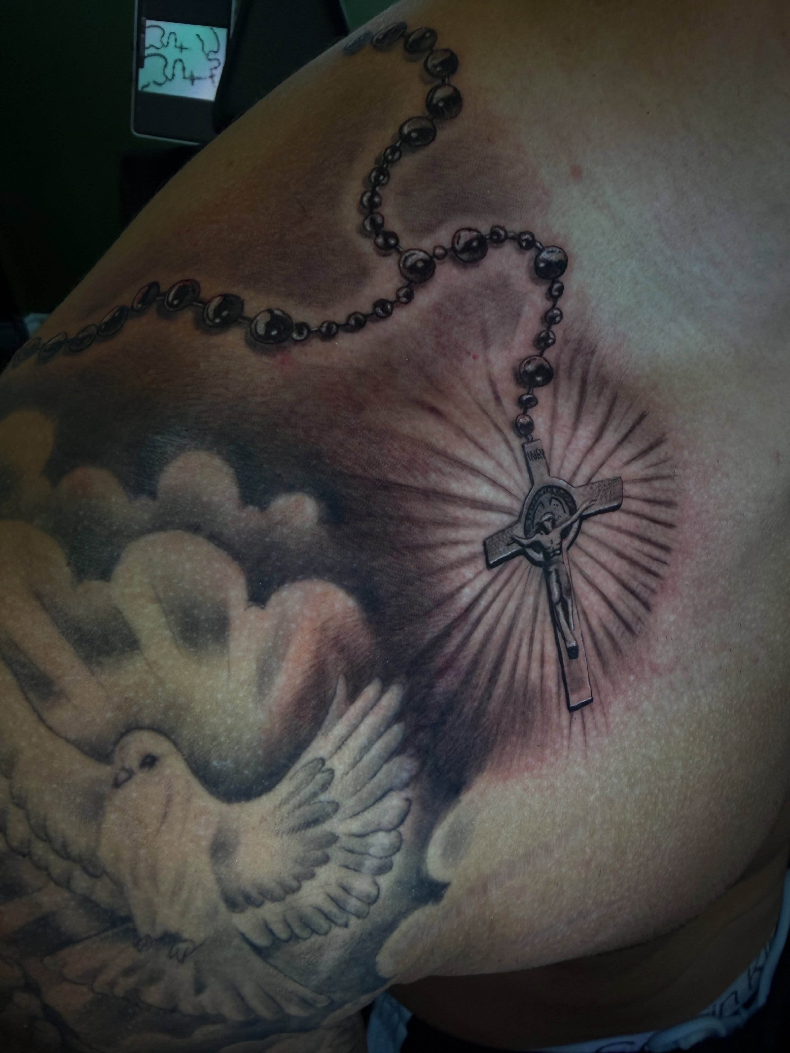 Rosary and crucifix realism tattoo on the shoulder by Vic