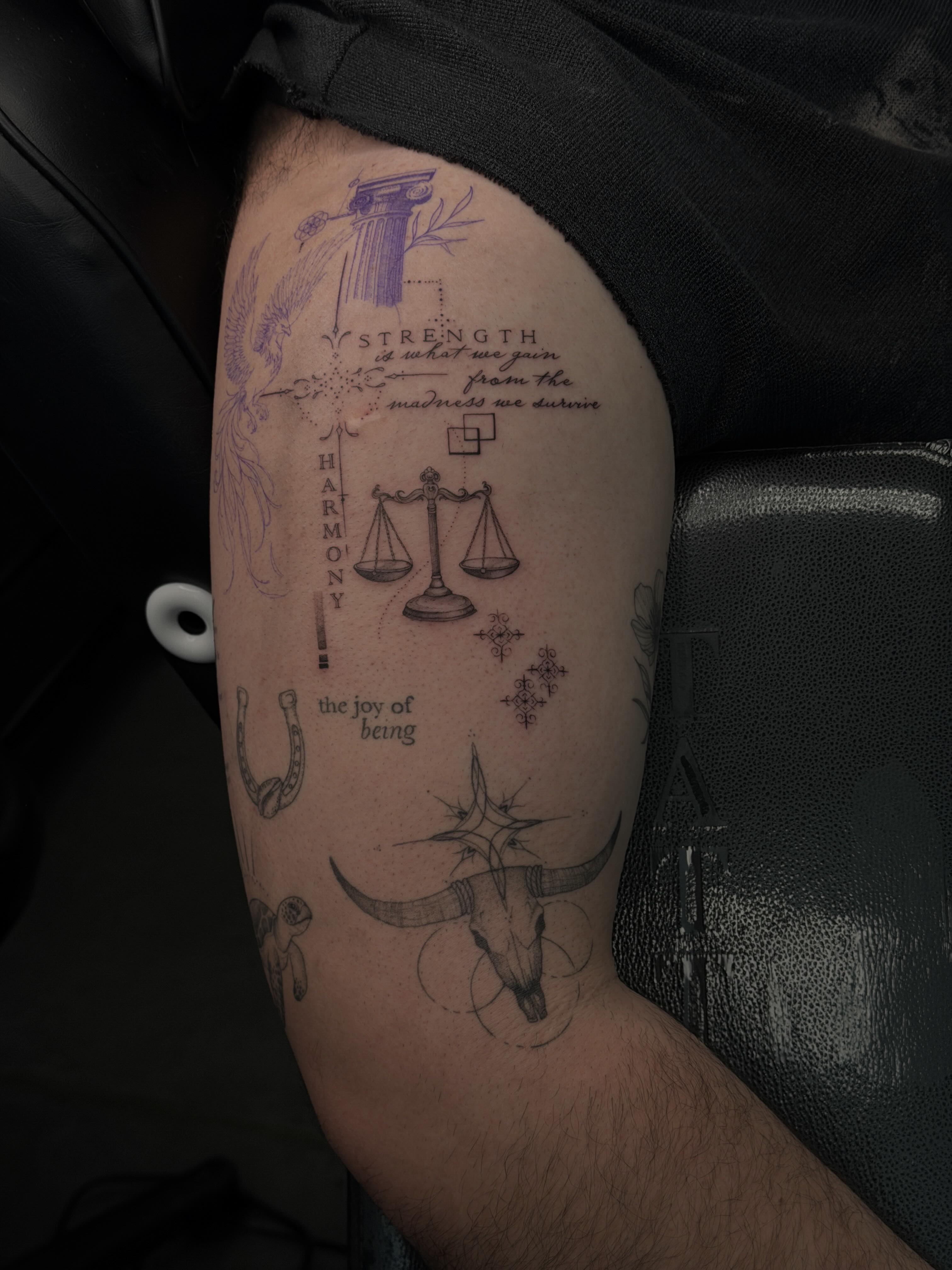 Balance scale and bull skull geometric tattoo on the upper arm by Hannah Matthews