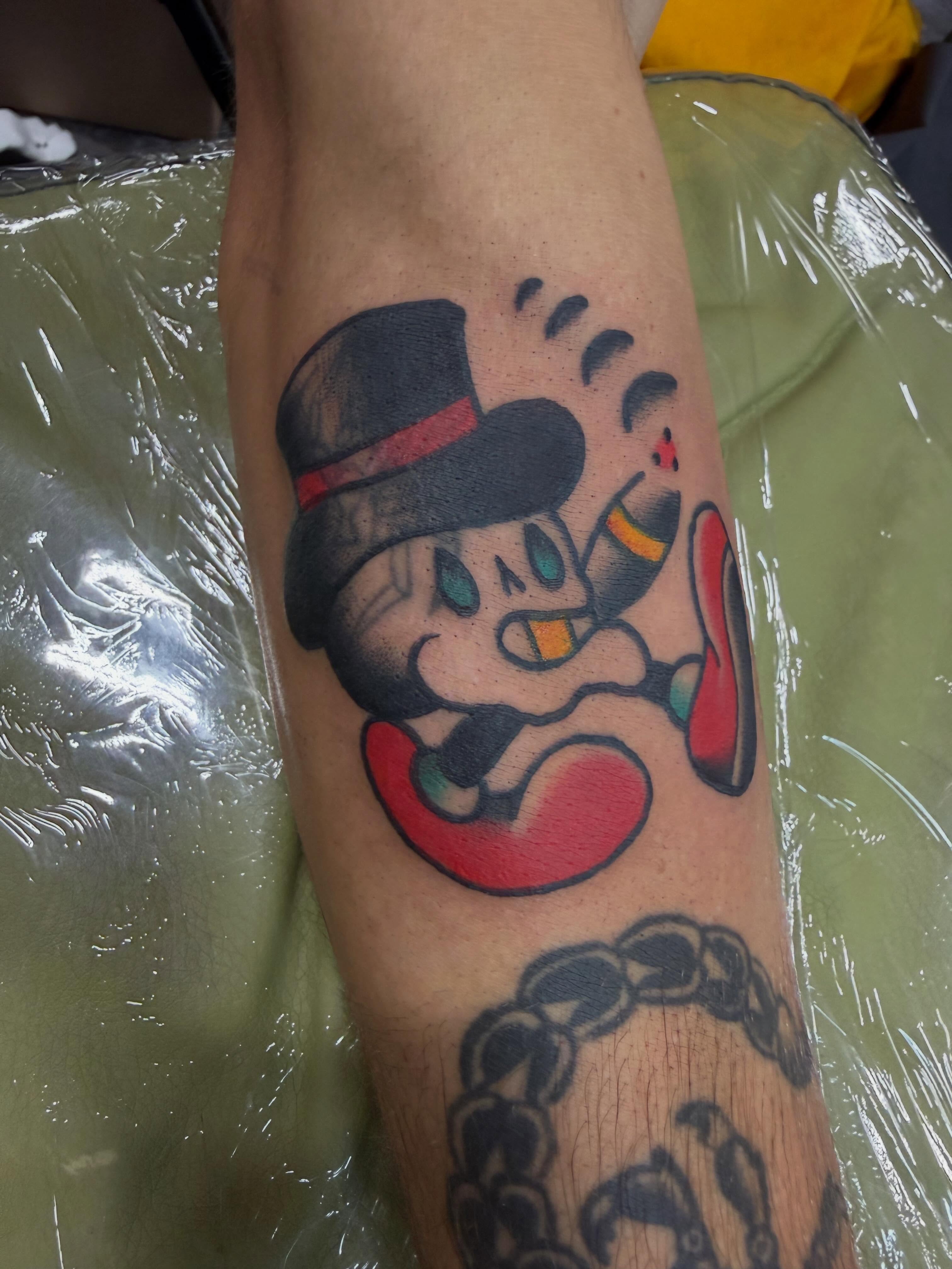 Mickey mouse American traditional tattoo on the forearm by Hannah Jean