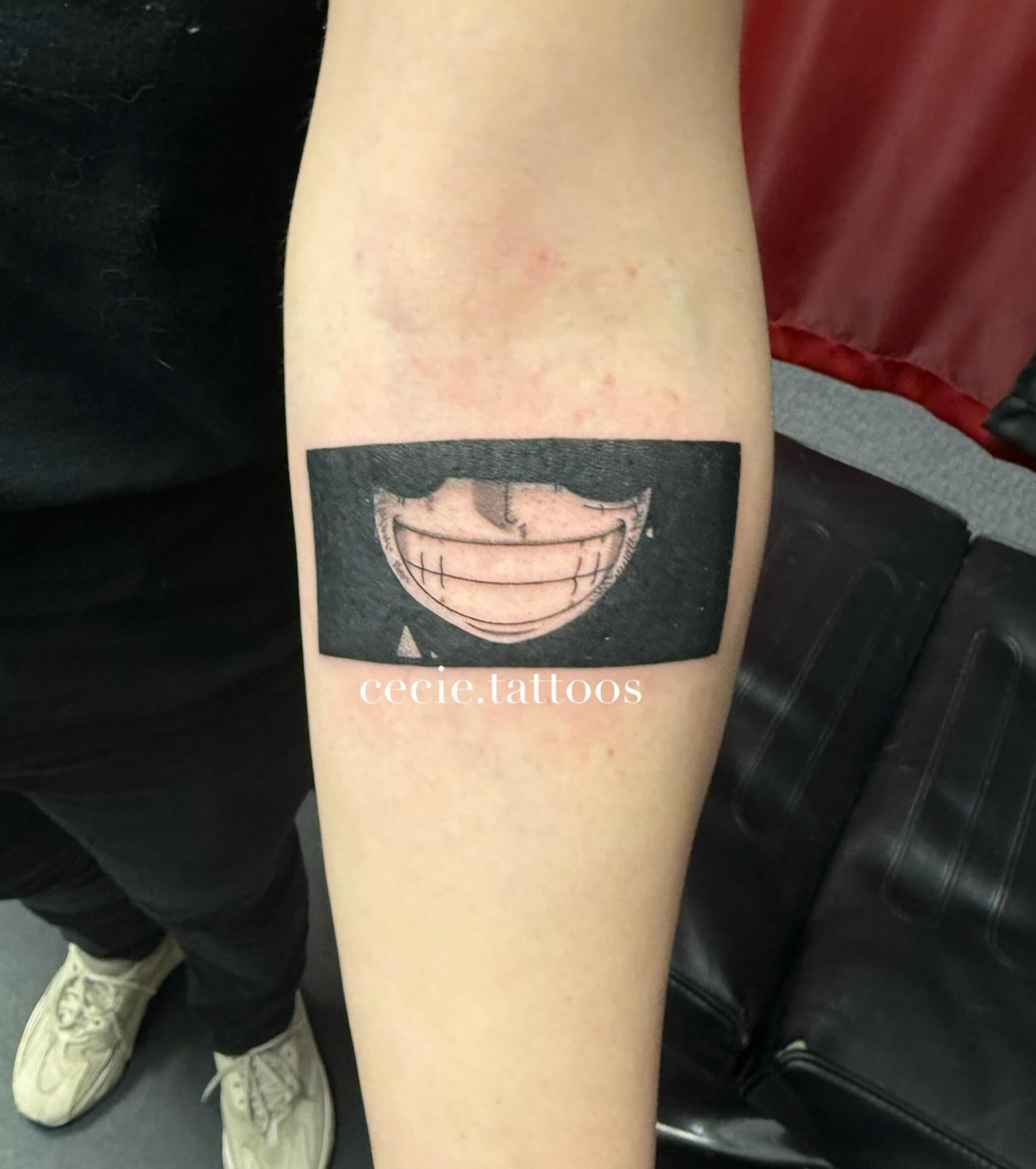Mask black and grey tattoo on the forearm by cecie moua