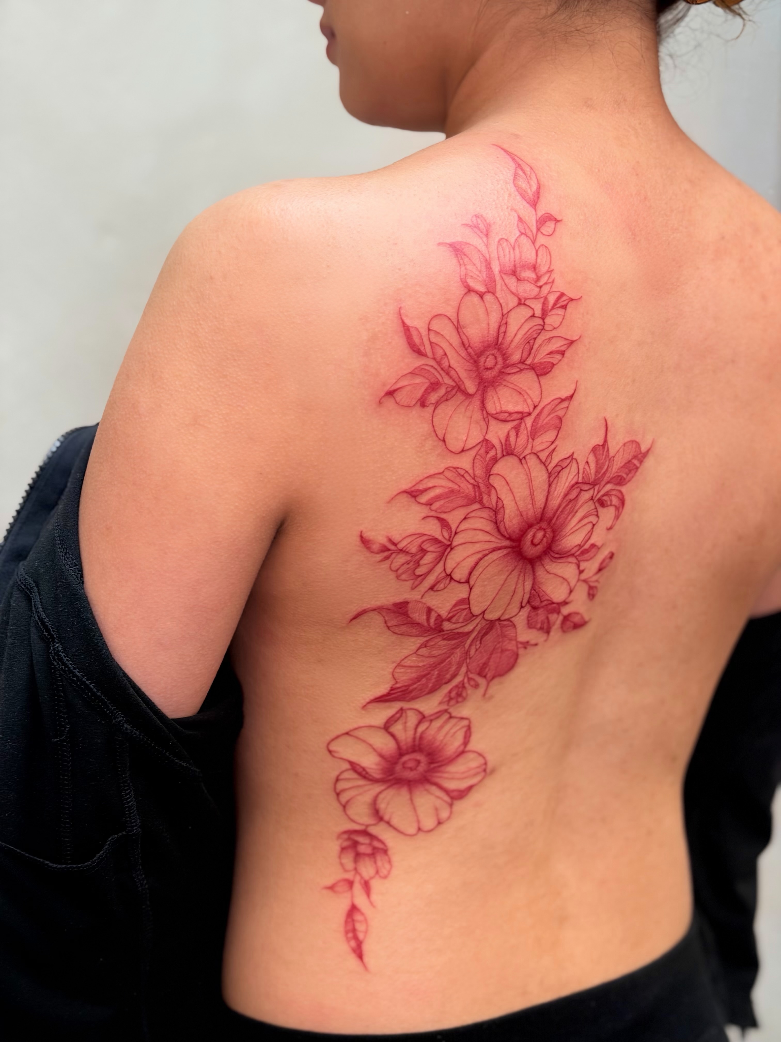 Flowers dotwork tattoo on the back by Bryan Nguyen