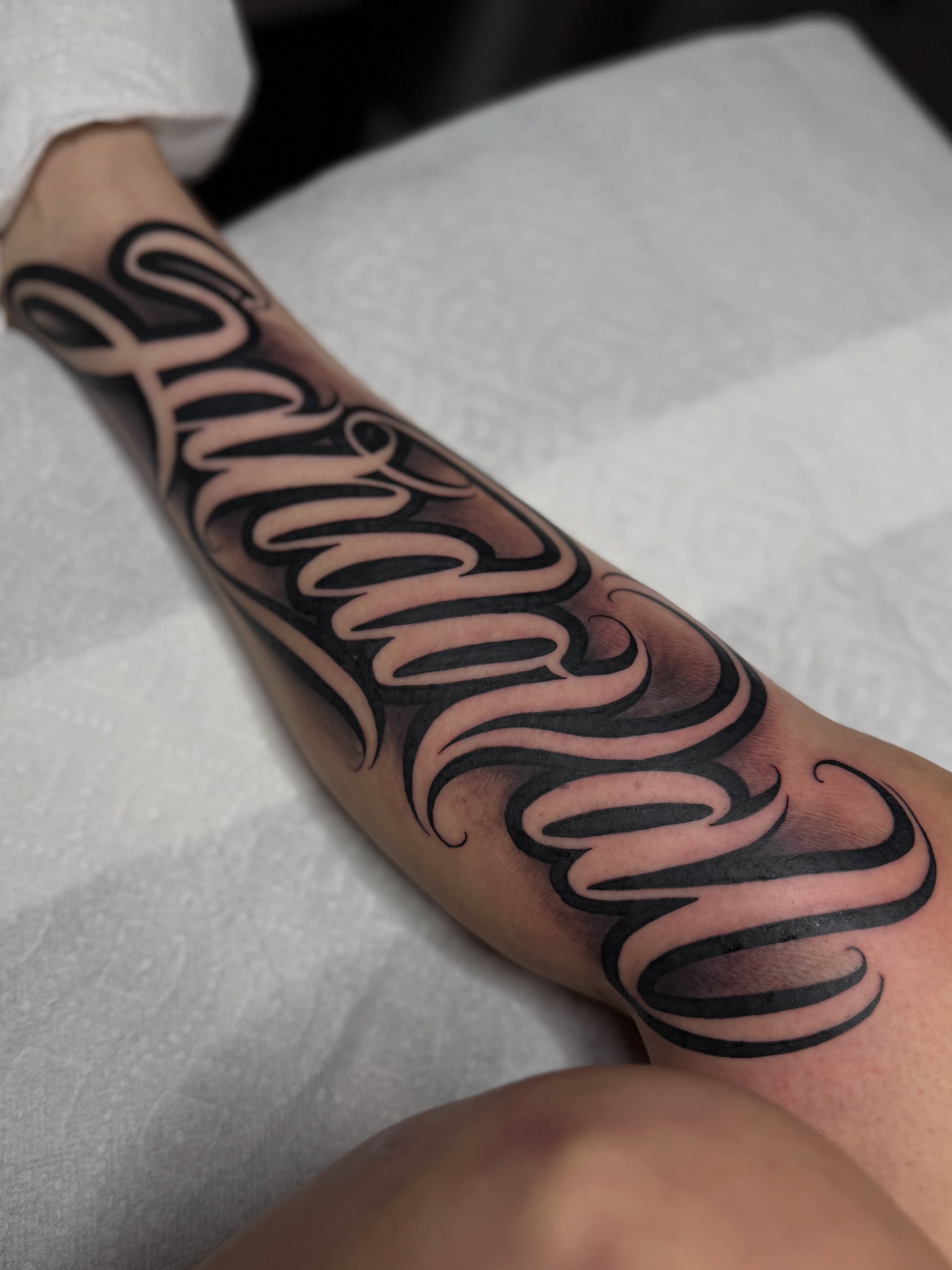 Script lettering lettering script tattoo on the forearm by Rocky G Inkz LLC