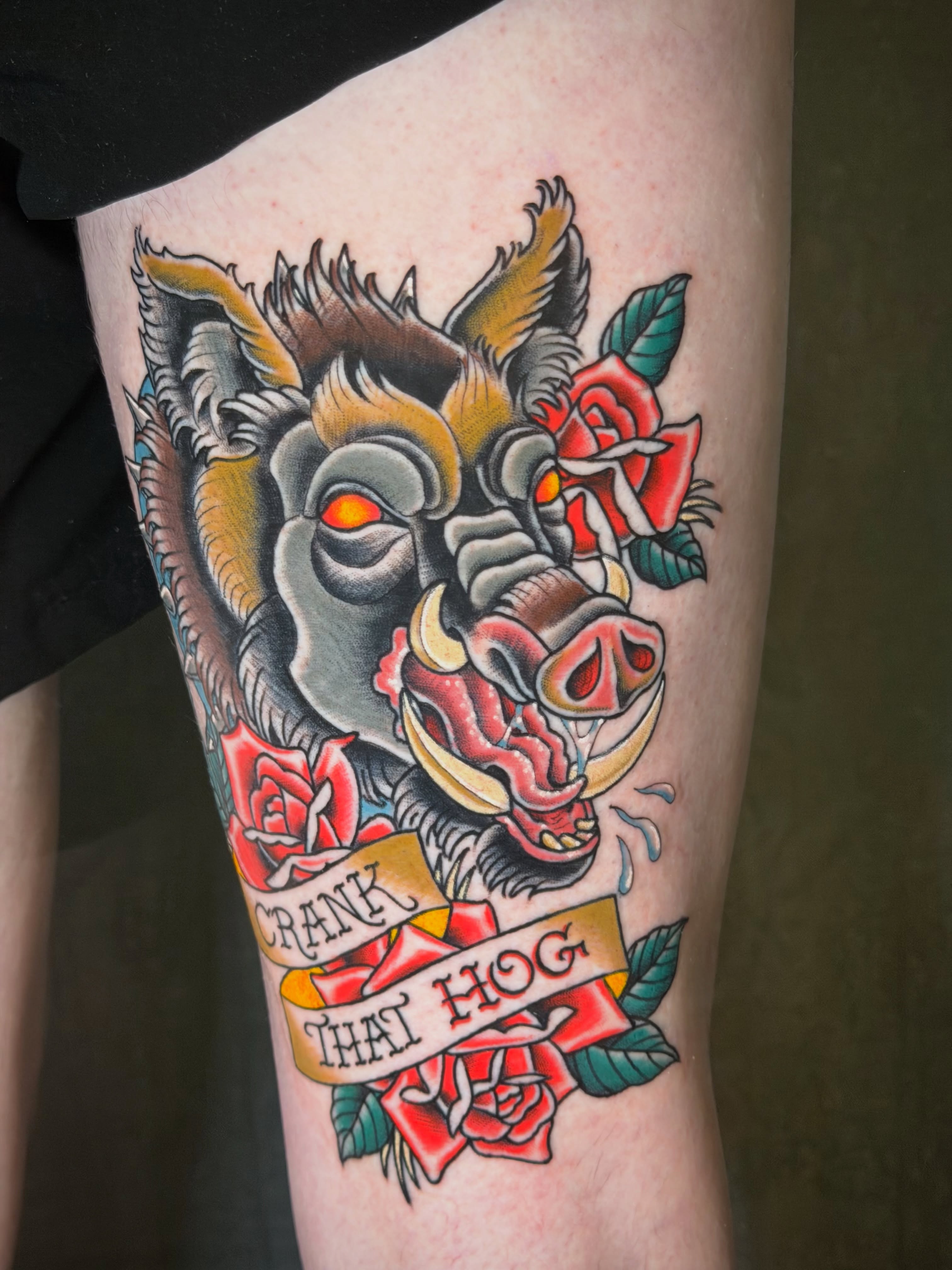 Pig head with roses American traditional tattoo on the forearm by Thad Collis