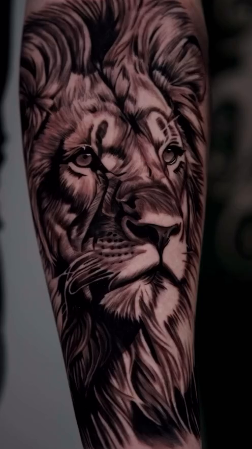Lion portrait tattoo realism tattoo on the upper arm by Travis