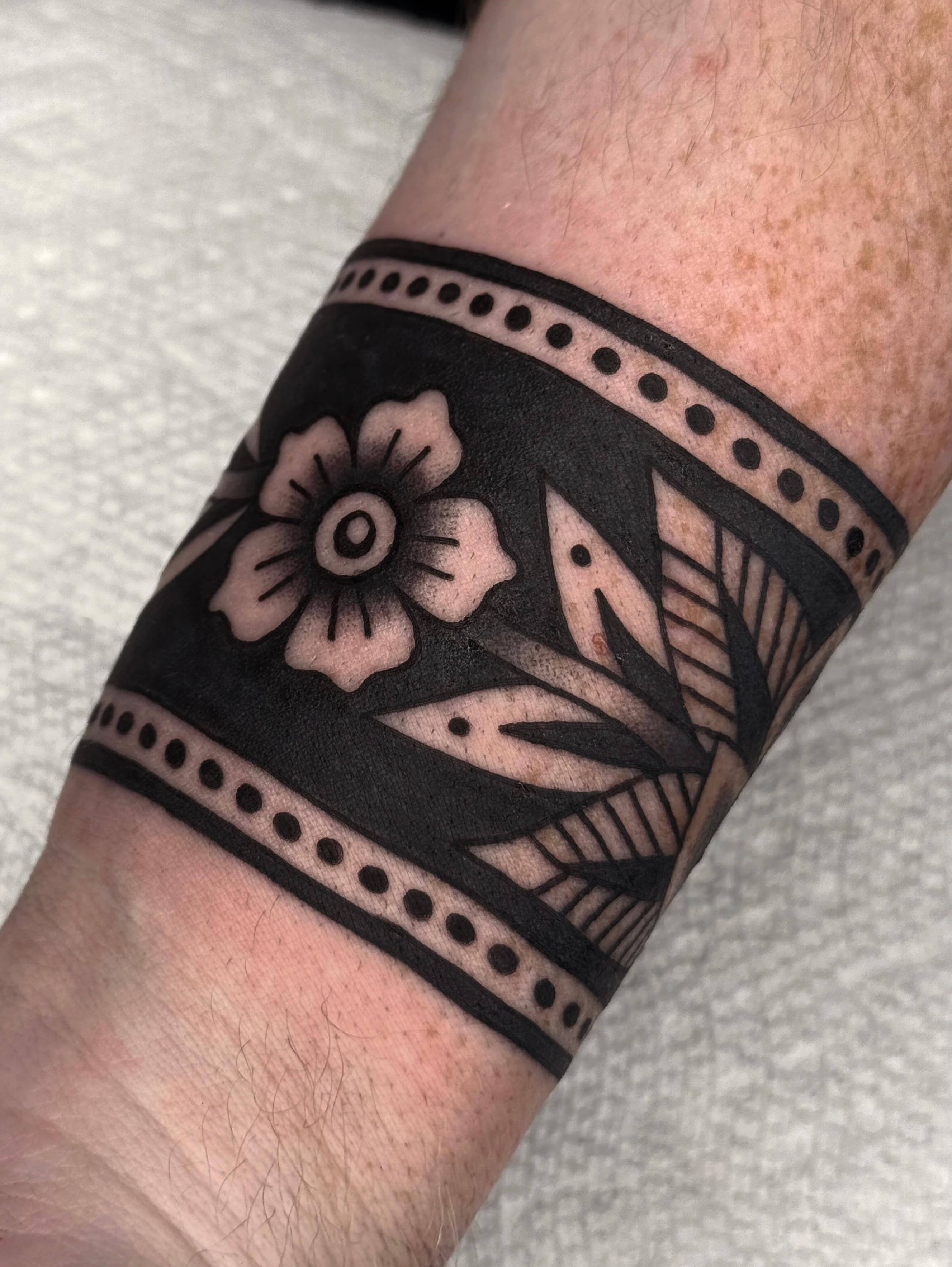 Floral pattern geometric tattoo on the forearm by Bridgette Carberry