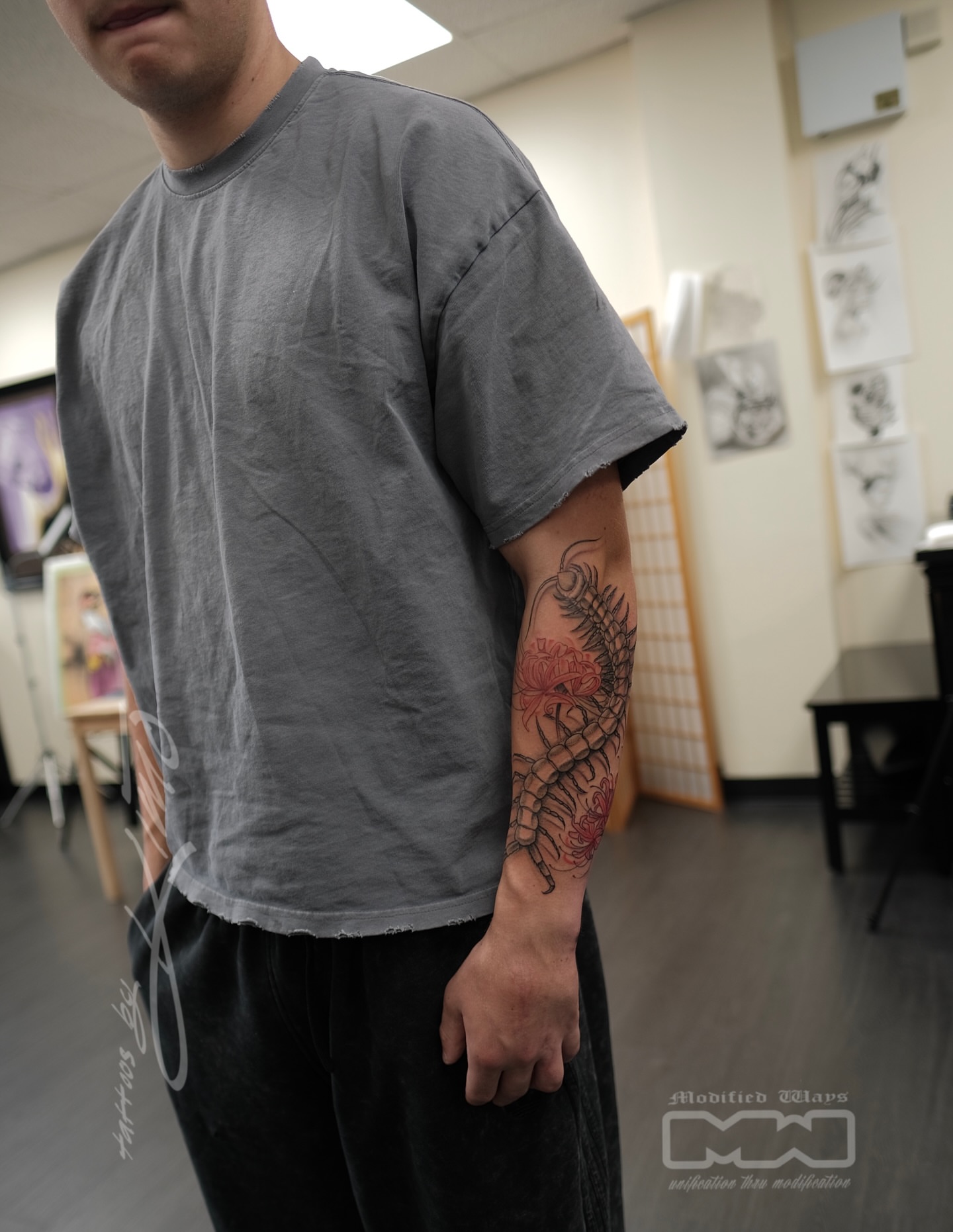 Serpent and flower neo-traditional tattoo on the forearm by Kansas City tattoo artist