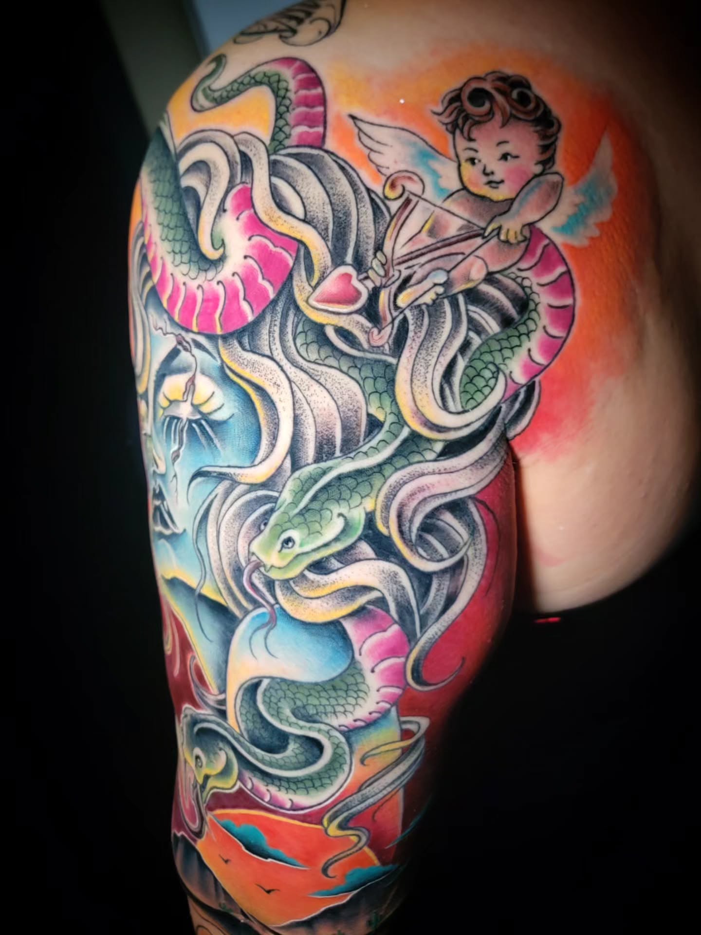 Cupid and snakes American traditional tattoo on the shoulder by Randyz Tattyz