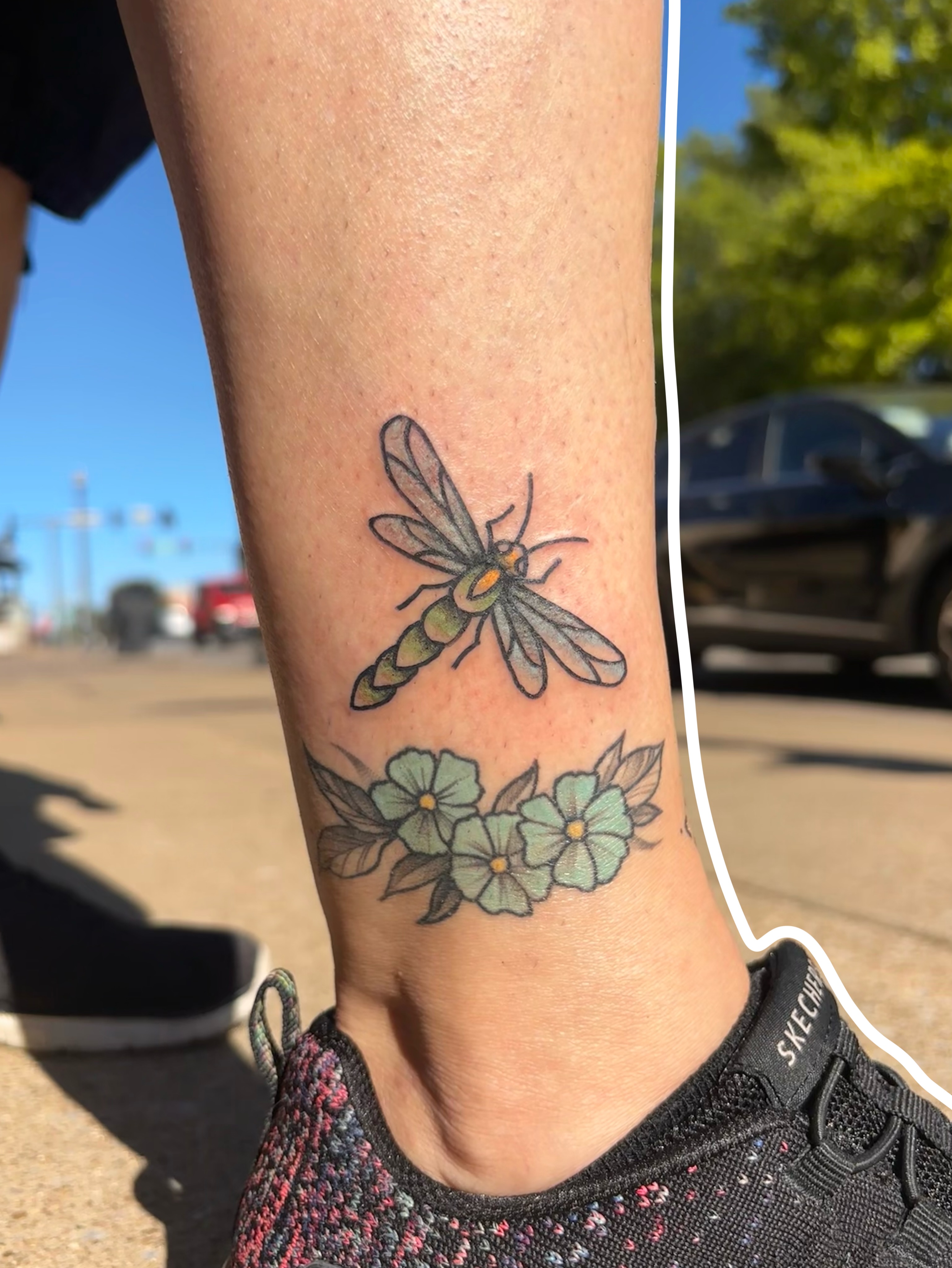 Bee and flowers realism tattoo on the forearm by Emmy Stepien