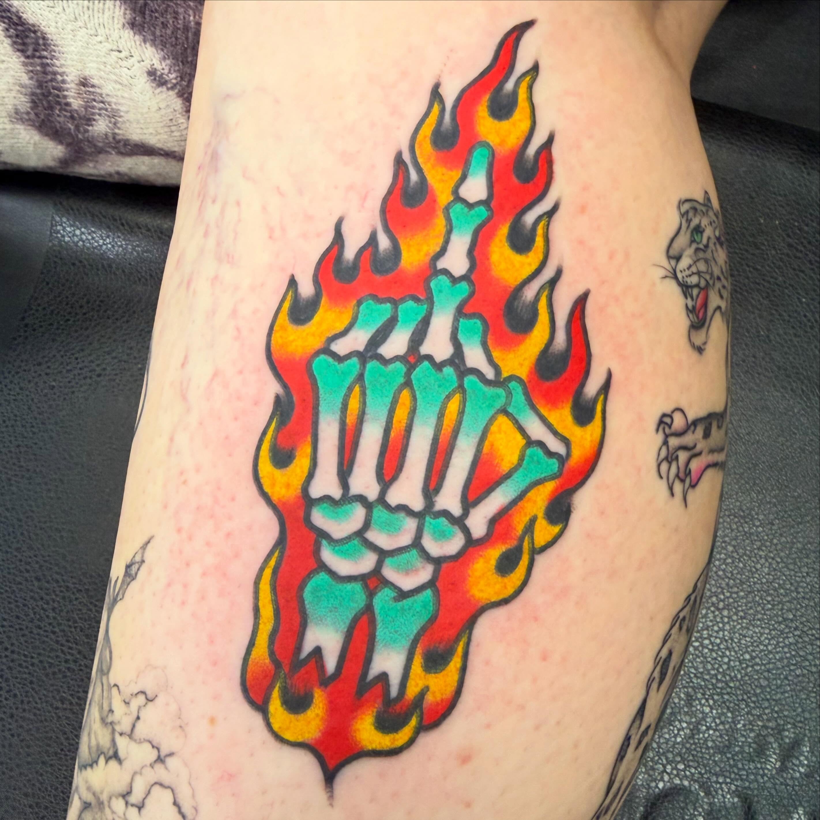 Flaming skeleton hand American traditional tattoo on the forearm by Max mogstad
