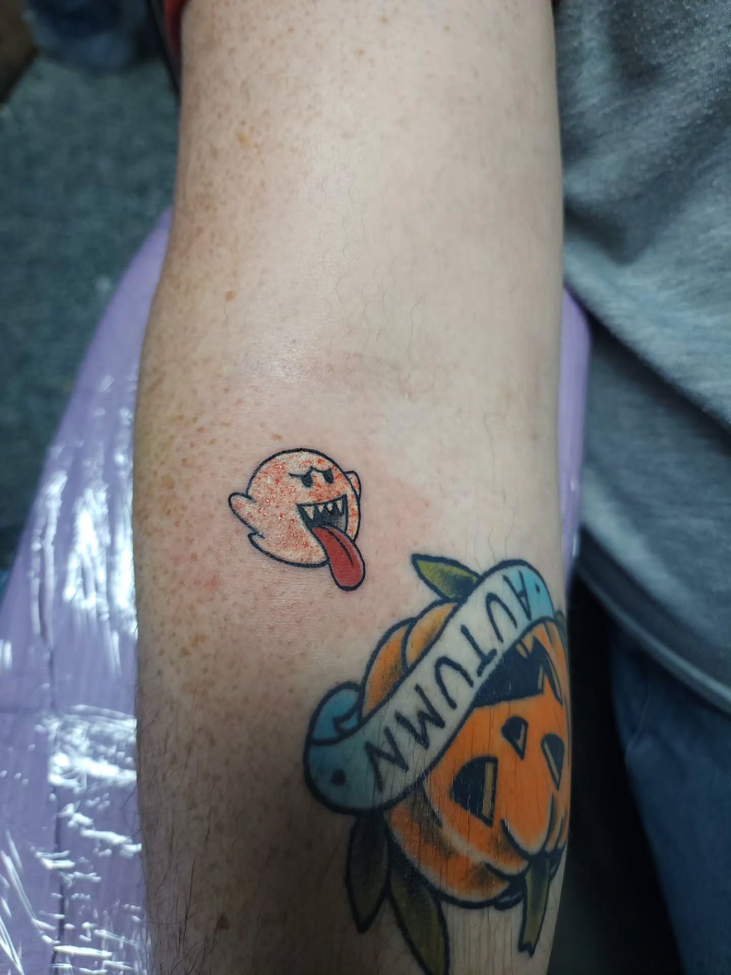 Ghost with tongue out American traditional tattoo on the forearm by xavia