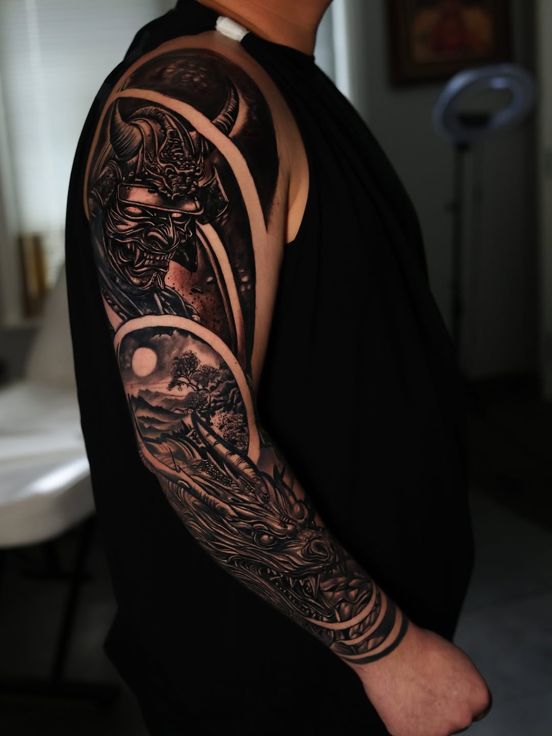 Samurai mask and dragon sleeve Japanese tattoo on the upper arm by Insight Ink Tattoo