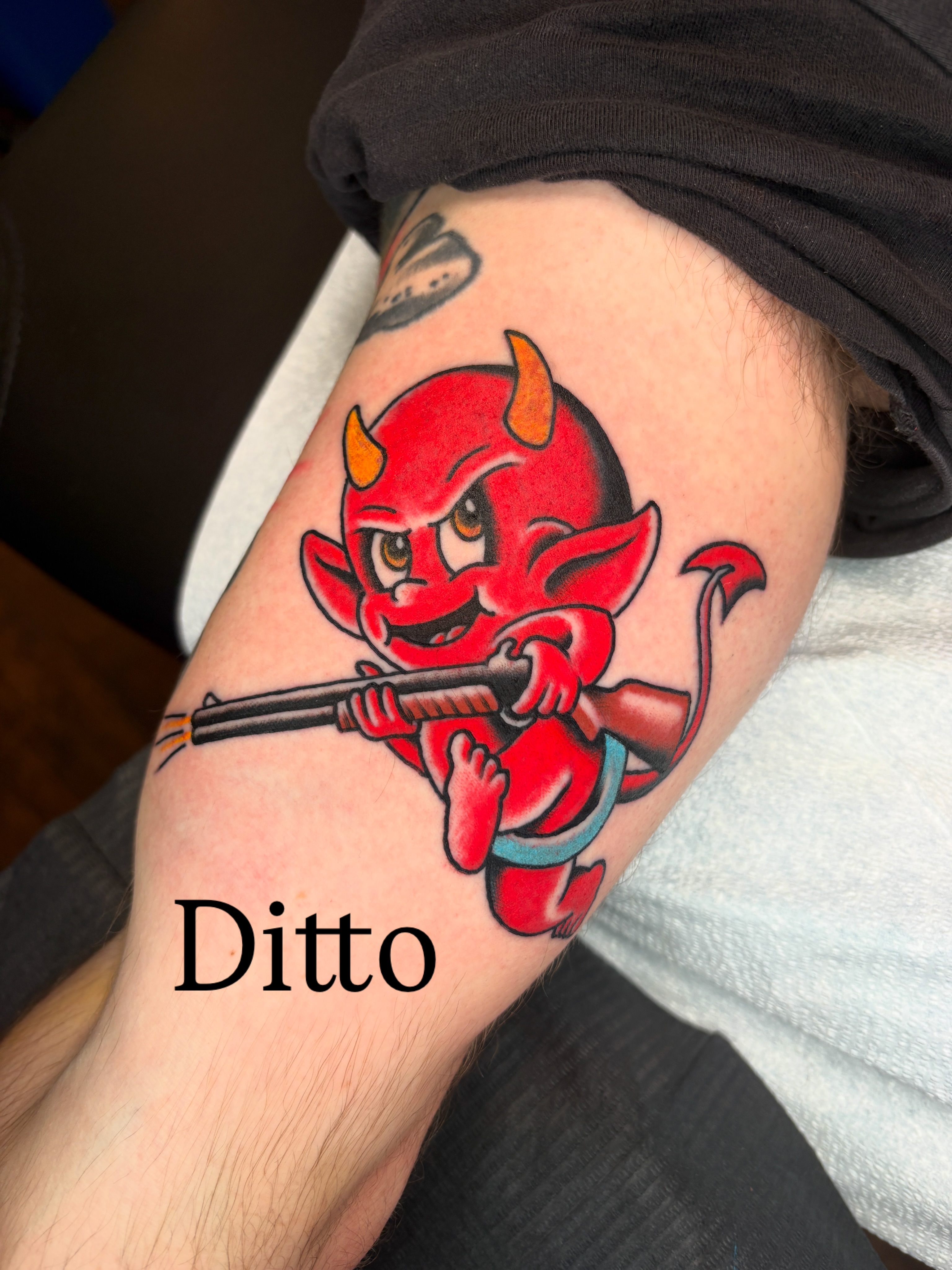 Red devil holding a gun American traditional tattoo on the forearm by Max Klapp, Austin, Texas