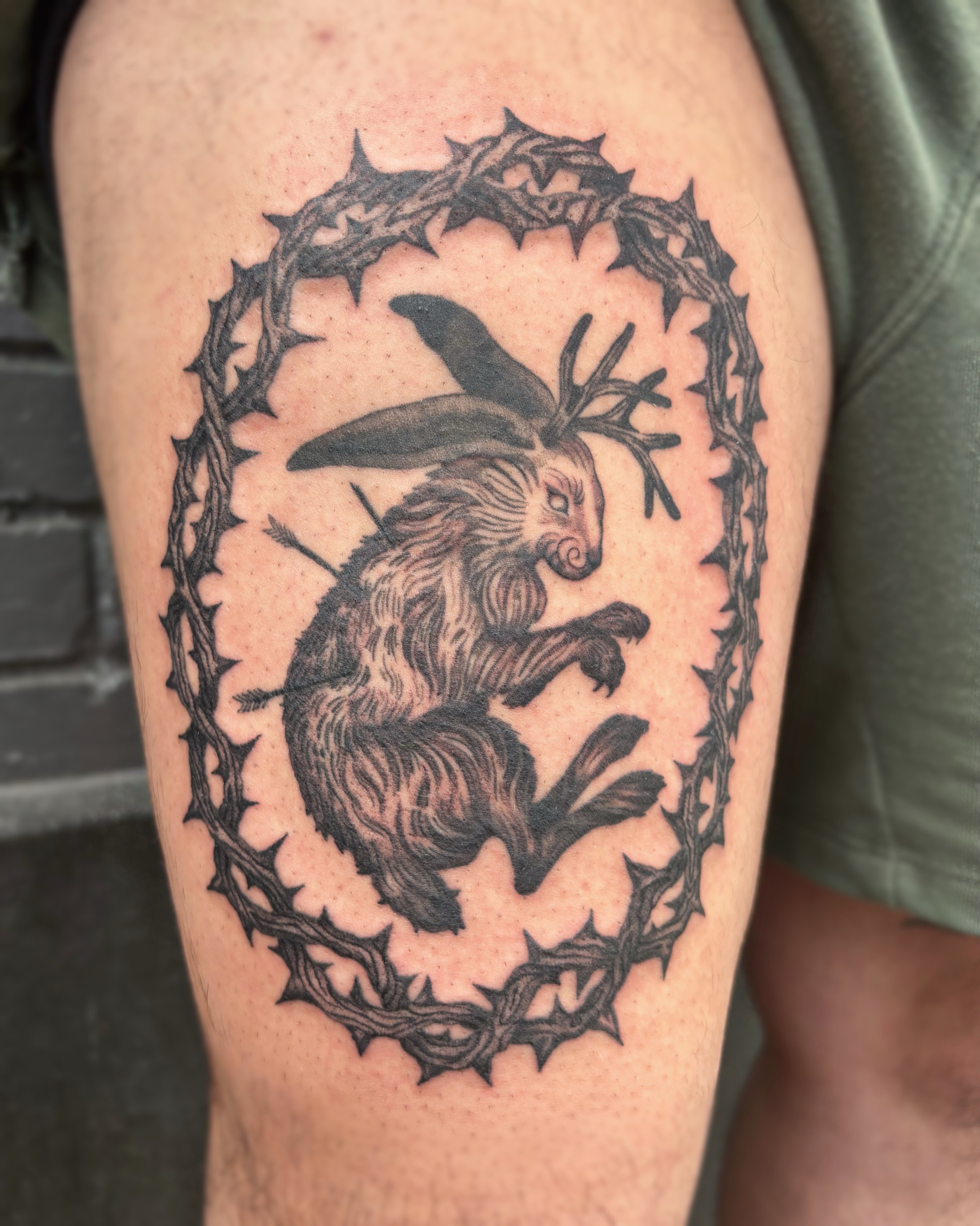 Hopping rabbit with antlers black and grey tattoo on the thigh by Cooper, Portland, Oregon