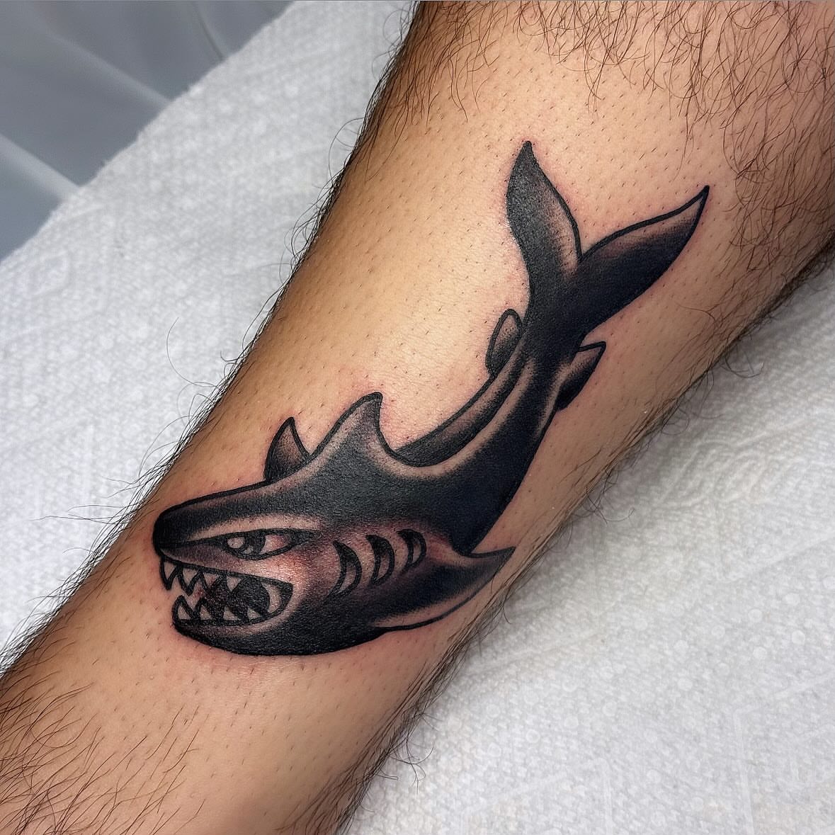 Shark black and grey tattoo on the forearm by Larry Love