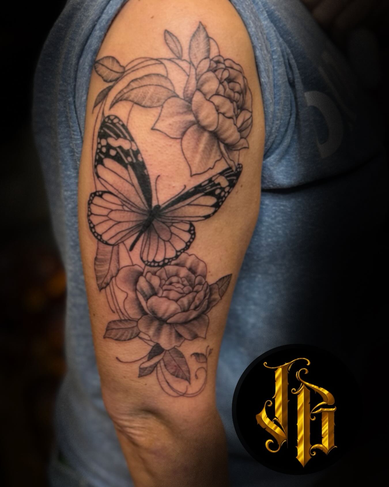 Butterfly and roses realism tattoo on the forearm by James Brooks