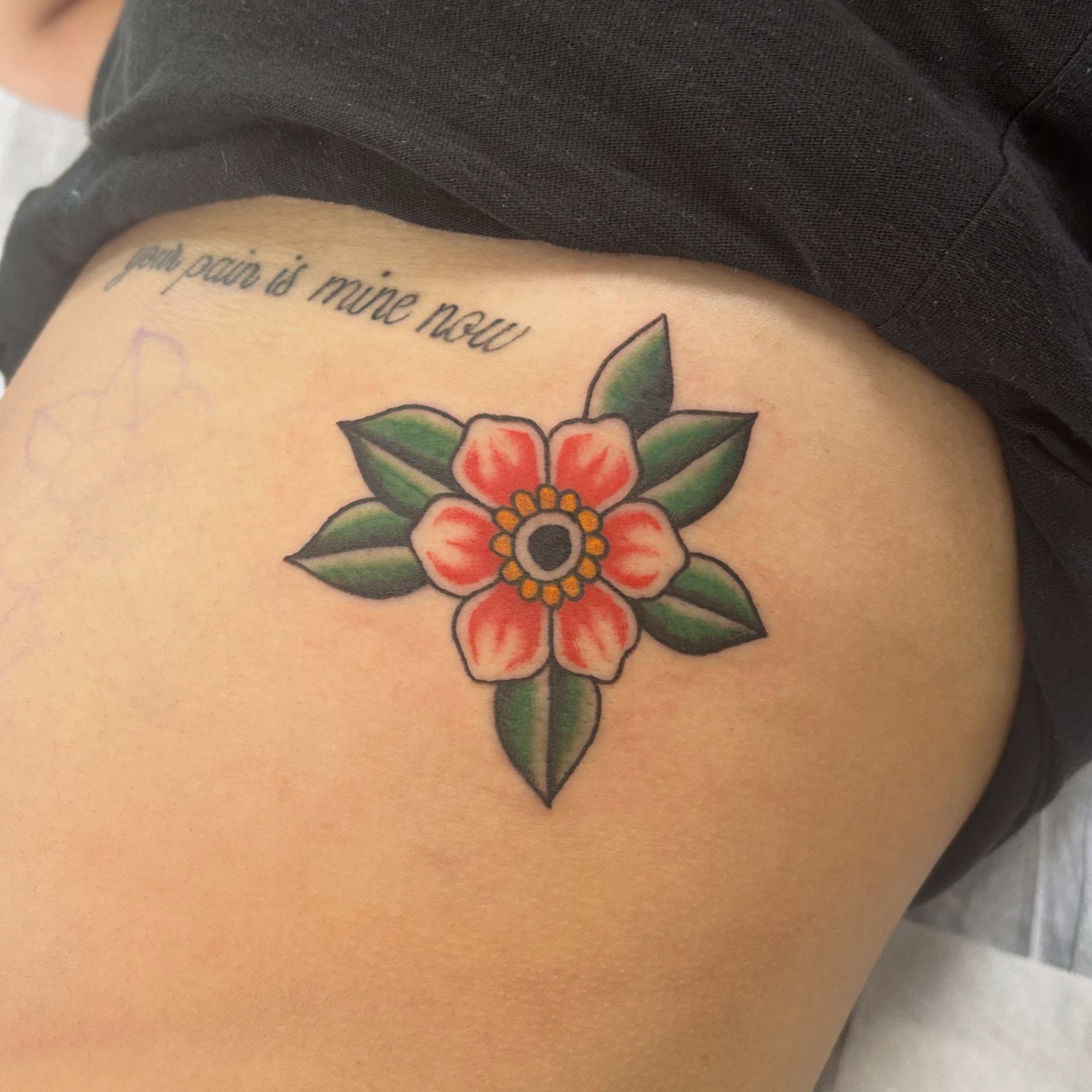 Flower American traditional tattoo on the thigh by Tawni Bender
