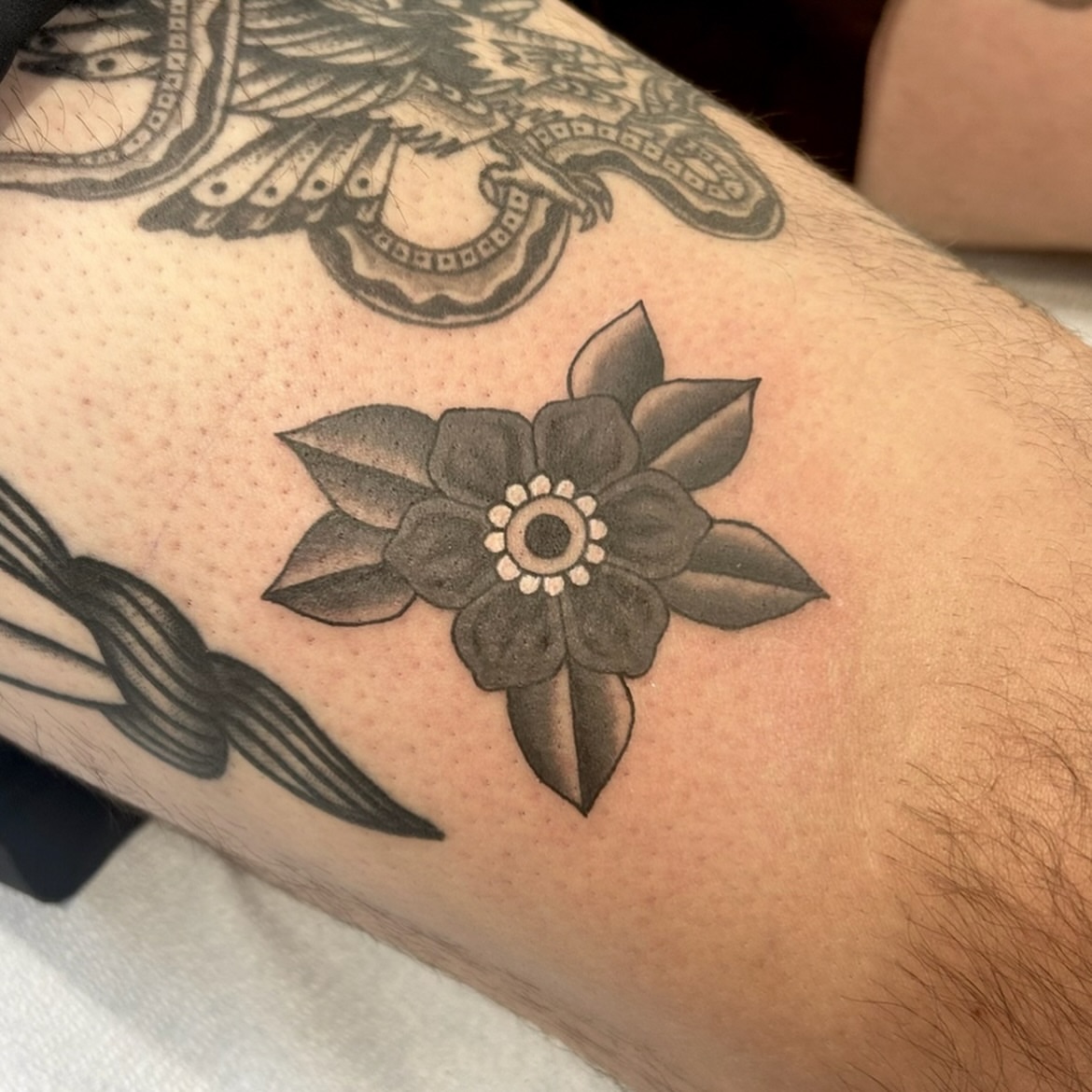 Flower black and grey tattoo on the forearm by Tawni Bender