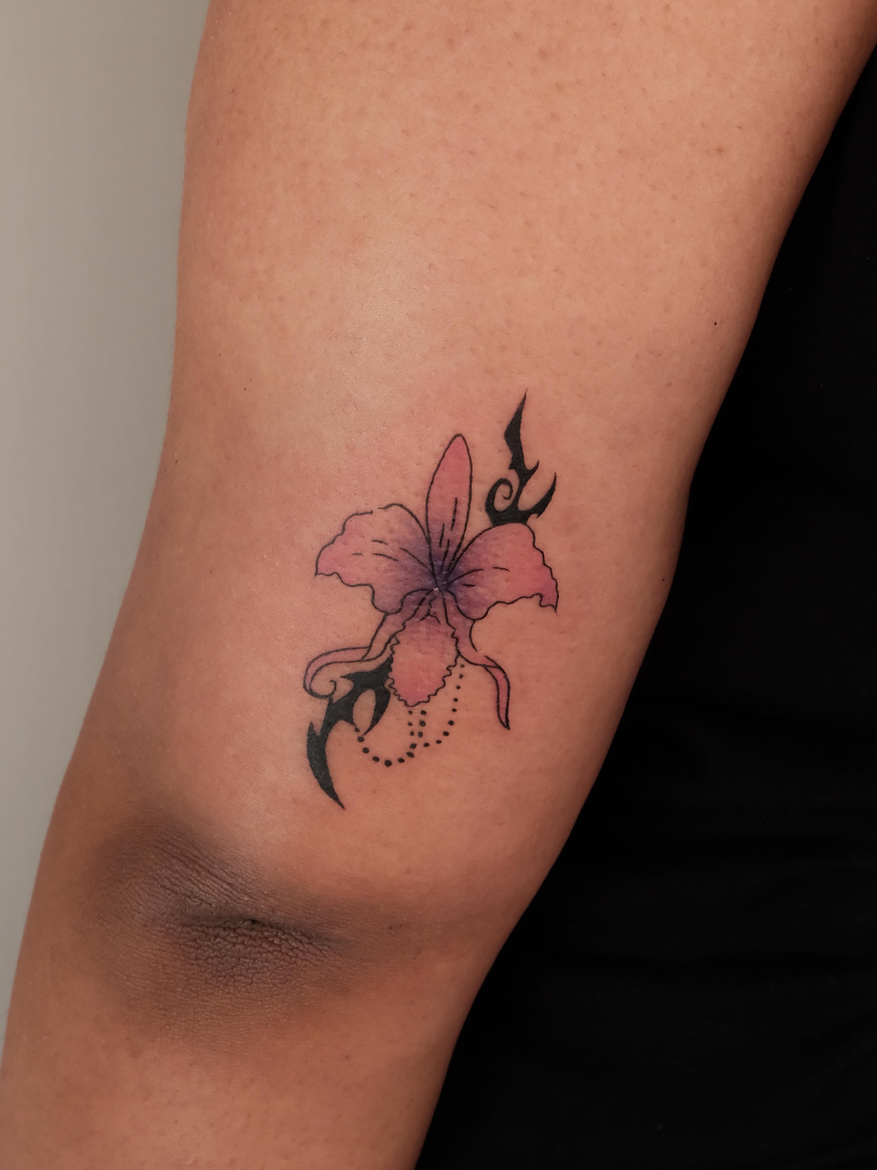 Flower with tribal elements dotwork tattoo on the forearm by Elana Hites