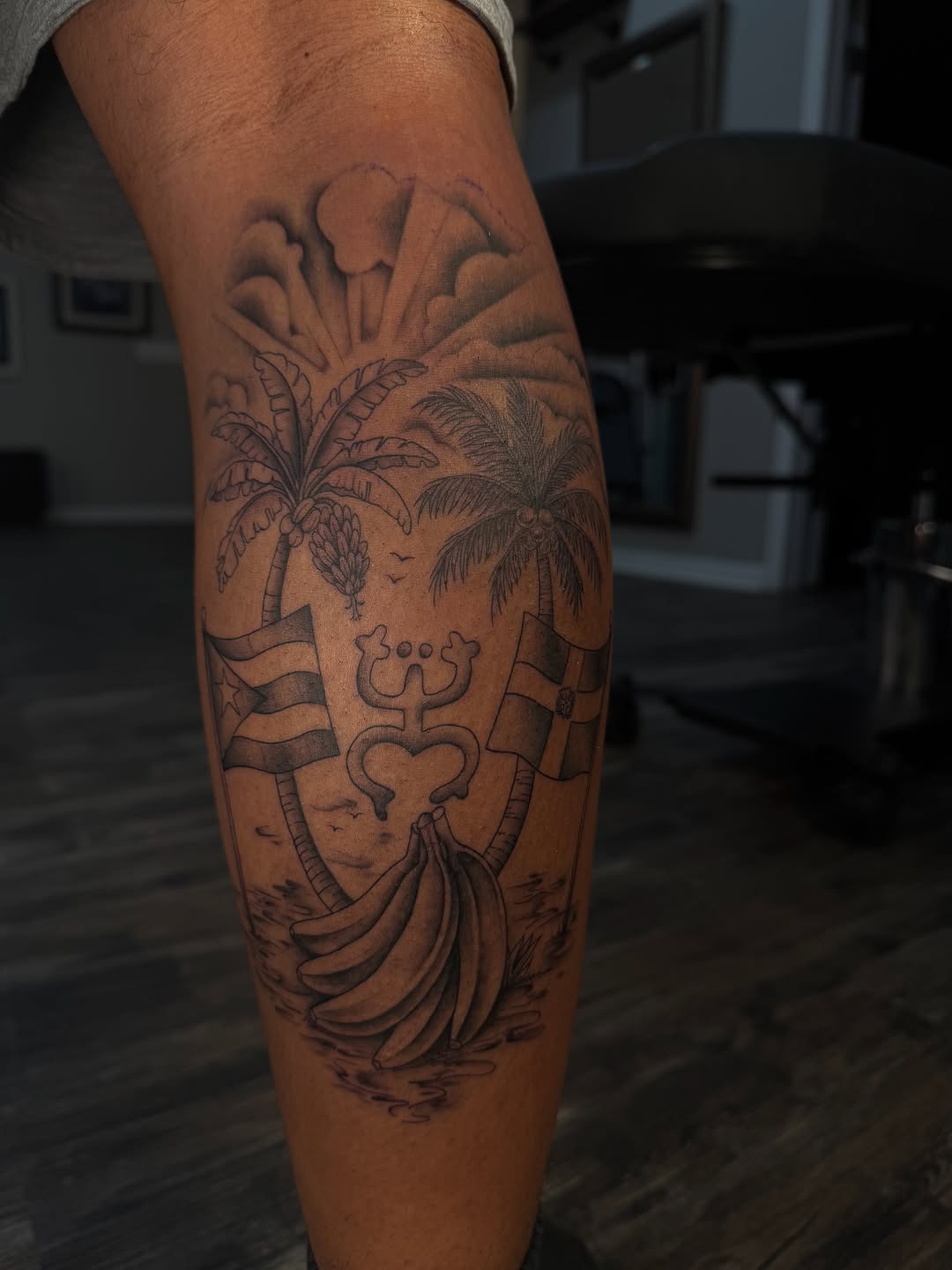 Tropical scene with flags and symbol tribal tattoo on the calf by 𝔍𝔲𝔩𝔦𝔞, New York, New York