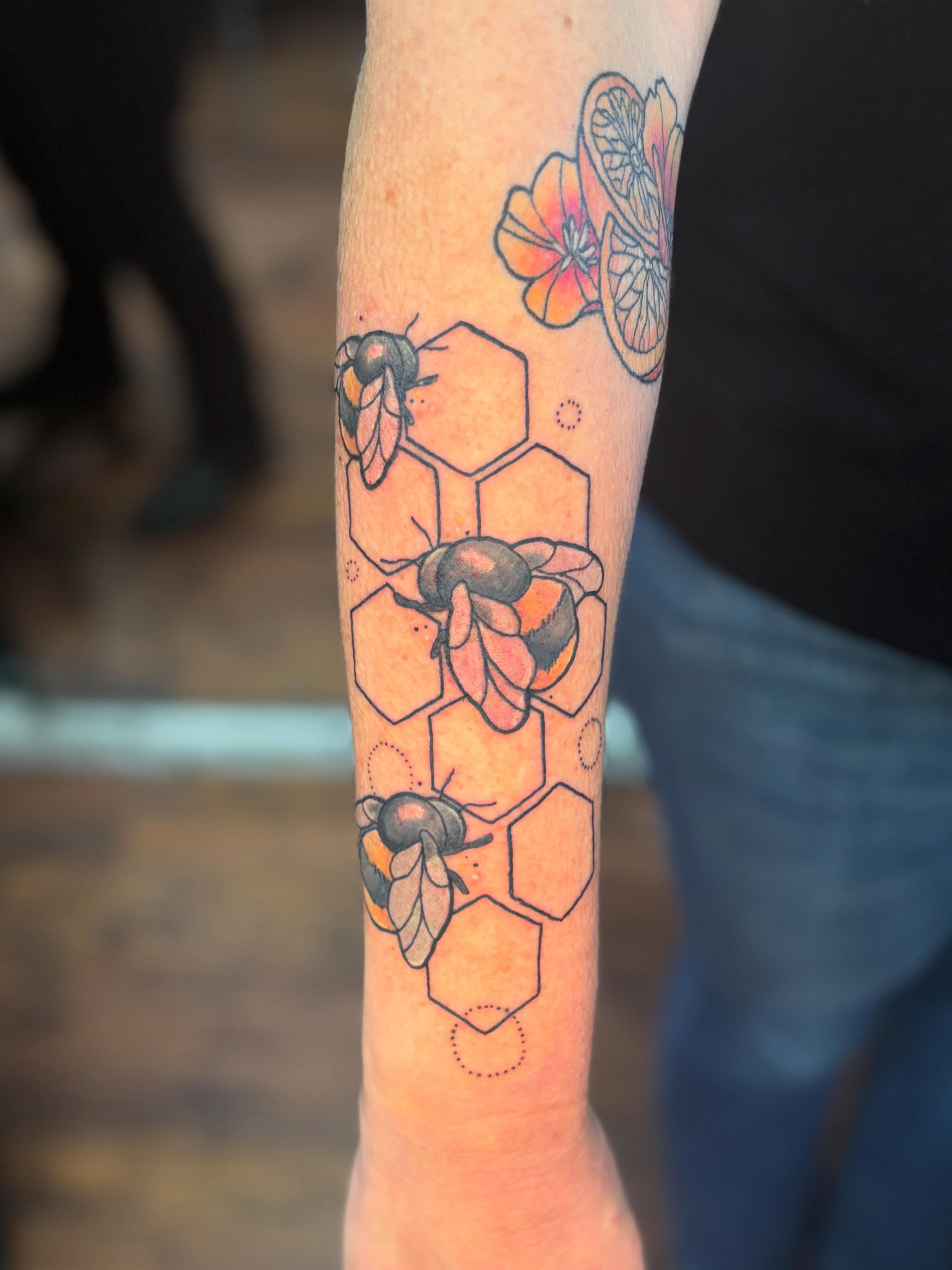 Bees and hexagons geometric tattoo on the forearm by Emma ๐
