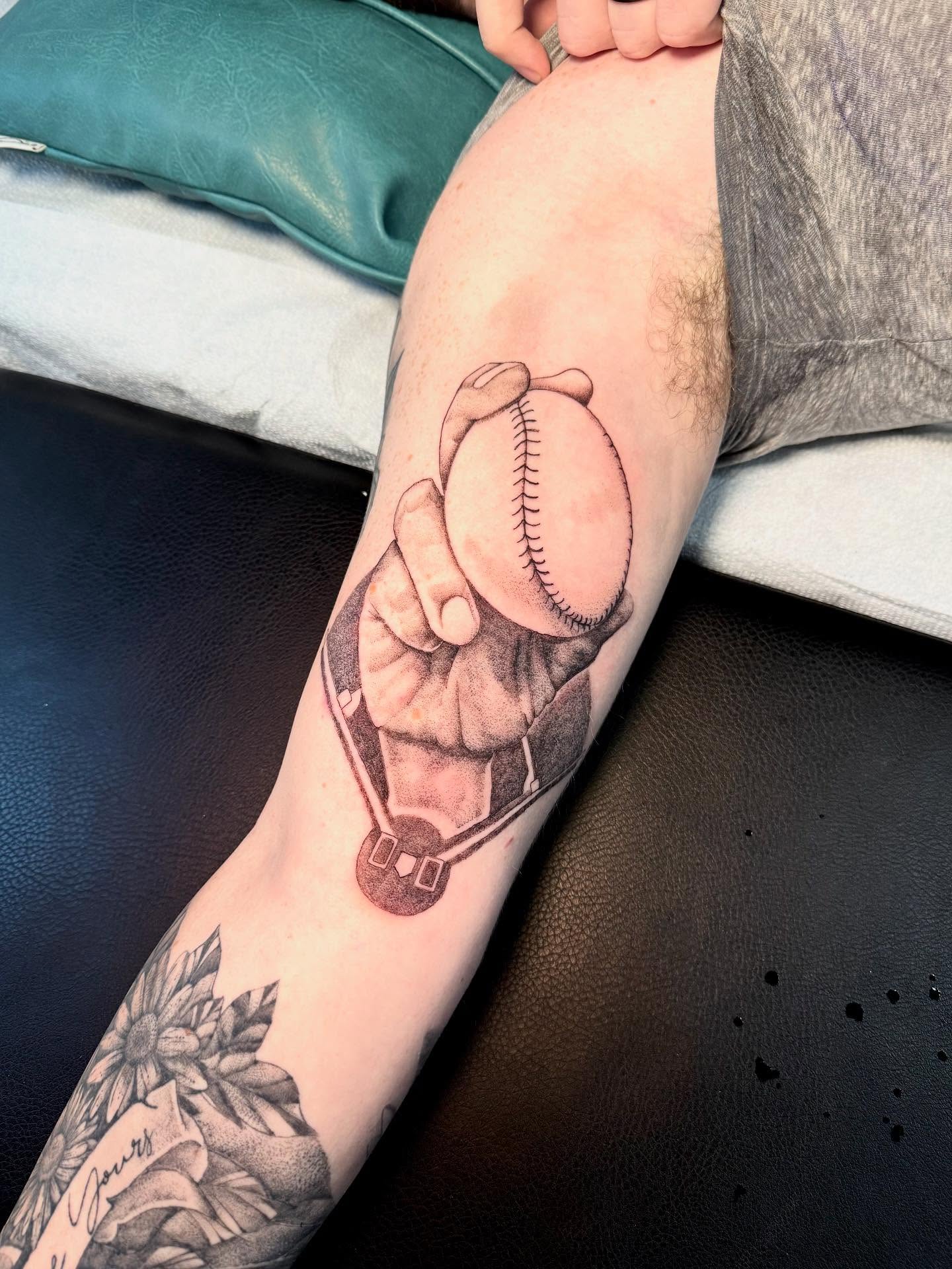 Baseball glove holding baseball black and grey tattoo on the forearm by C.J. Pennington