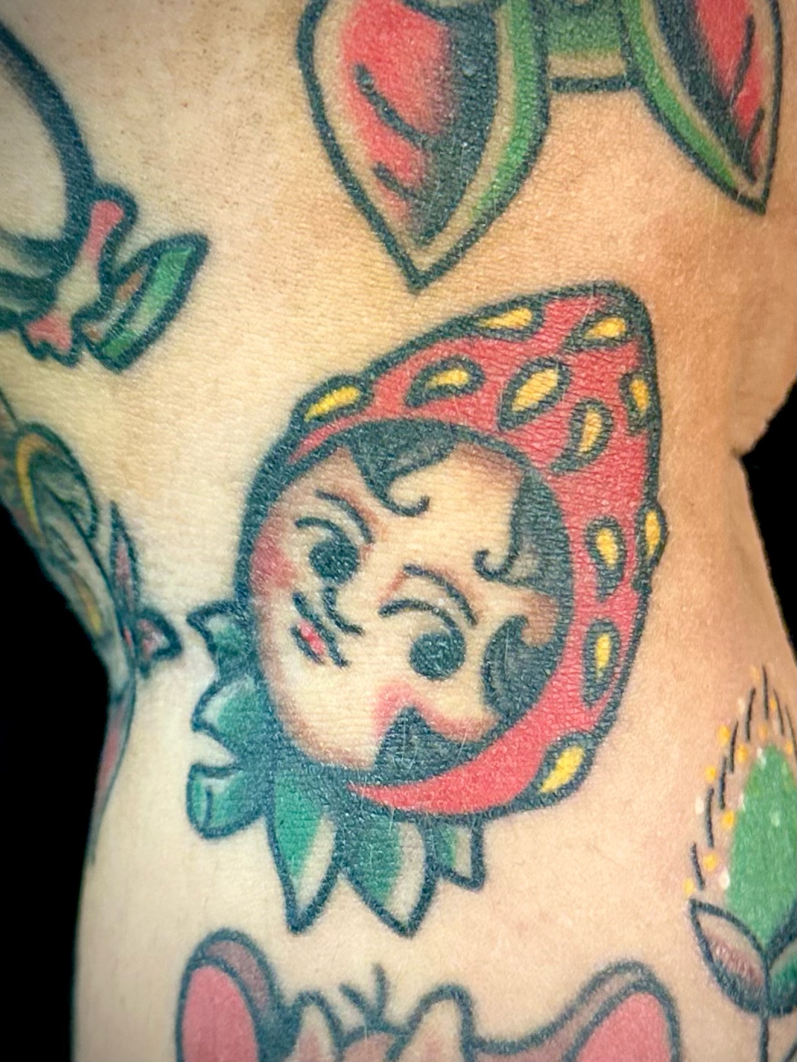 Sun American traditional tattoo on the torso by Josh Robinson