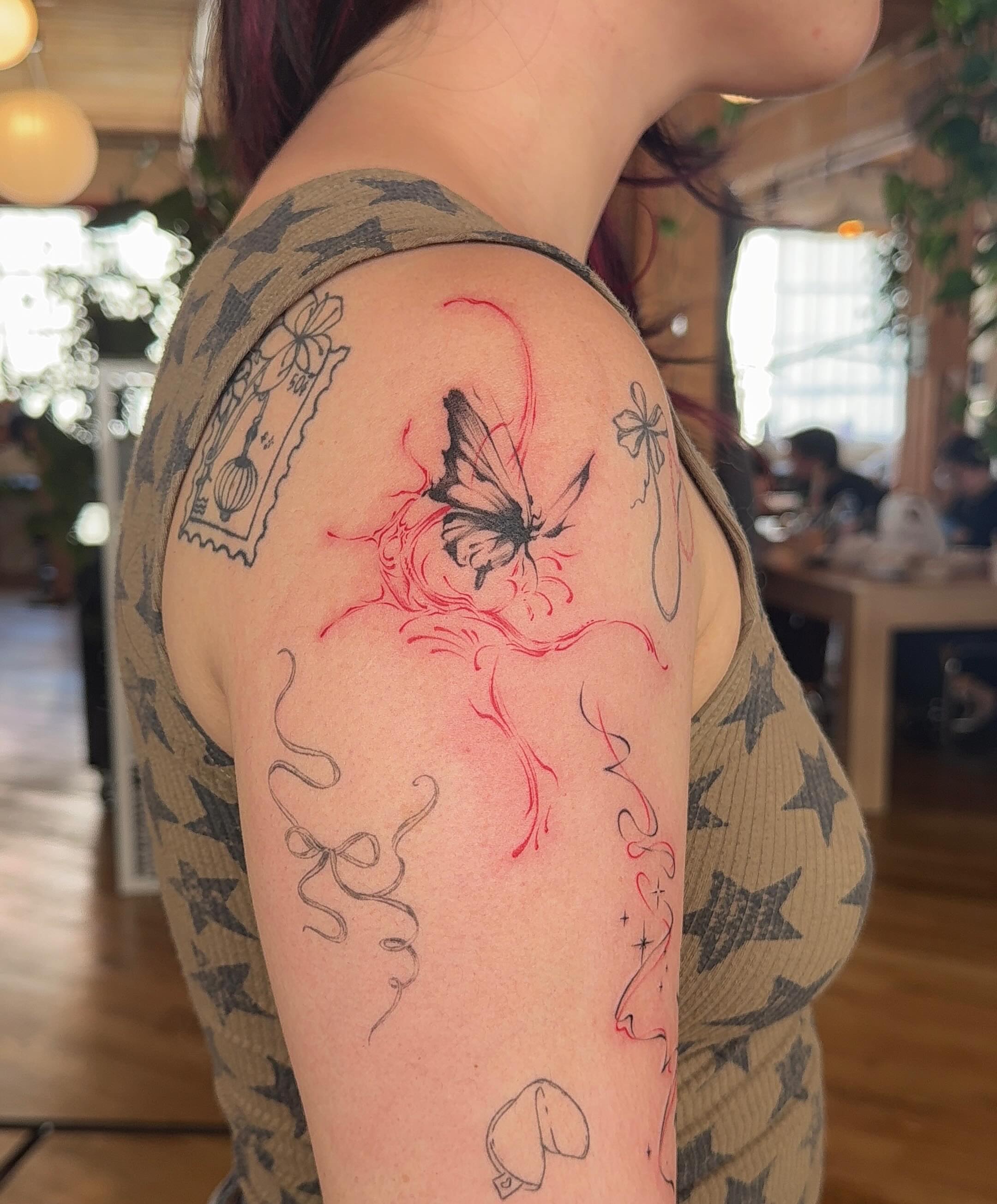 Butterfly watercolor tattoo on the shoulder by Ethan