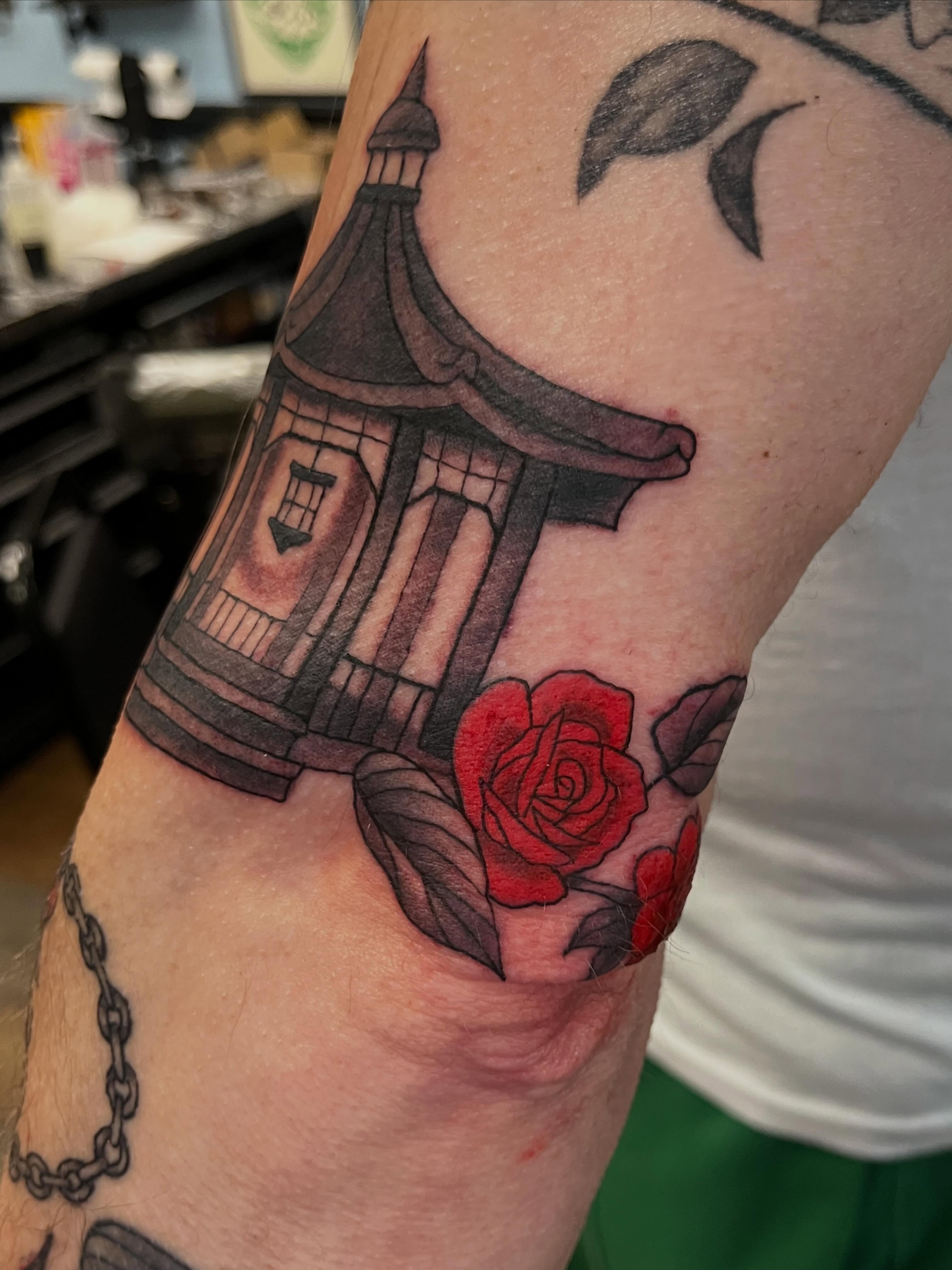 Pagoda and rose realism tattoo on the forearm by Brianna Jo Ballinghoff