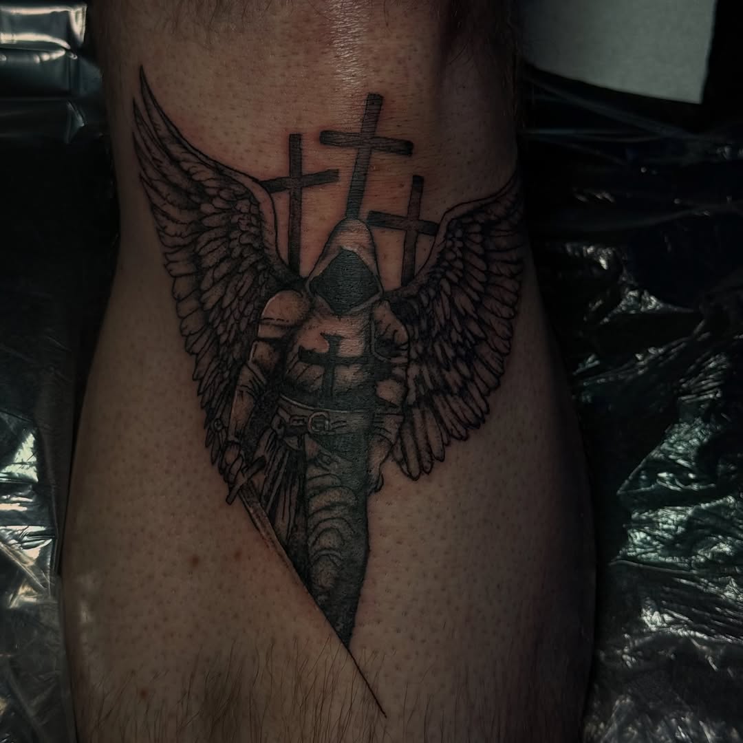 Angel with sword and crosses realism tattoo on the thigh by licensed charlotte tattoo artist