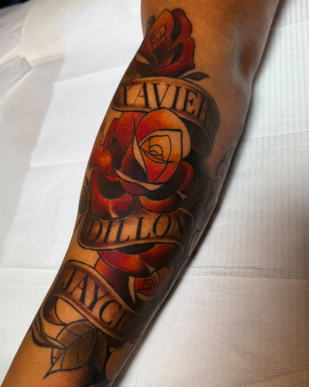 Roses and names American traditional tattoo on the forearm by Tattoos By Lola Cavotta, Willoughby, Ohio
