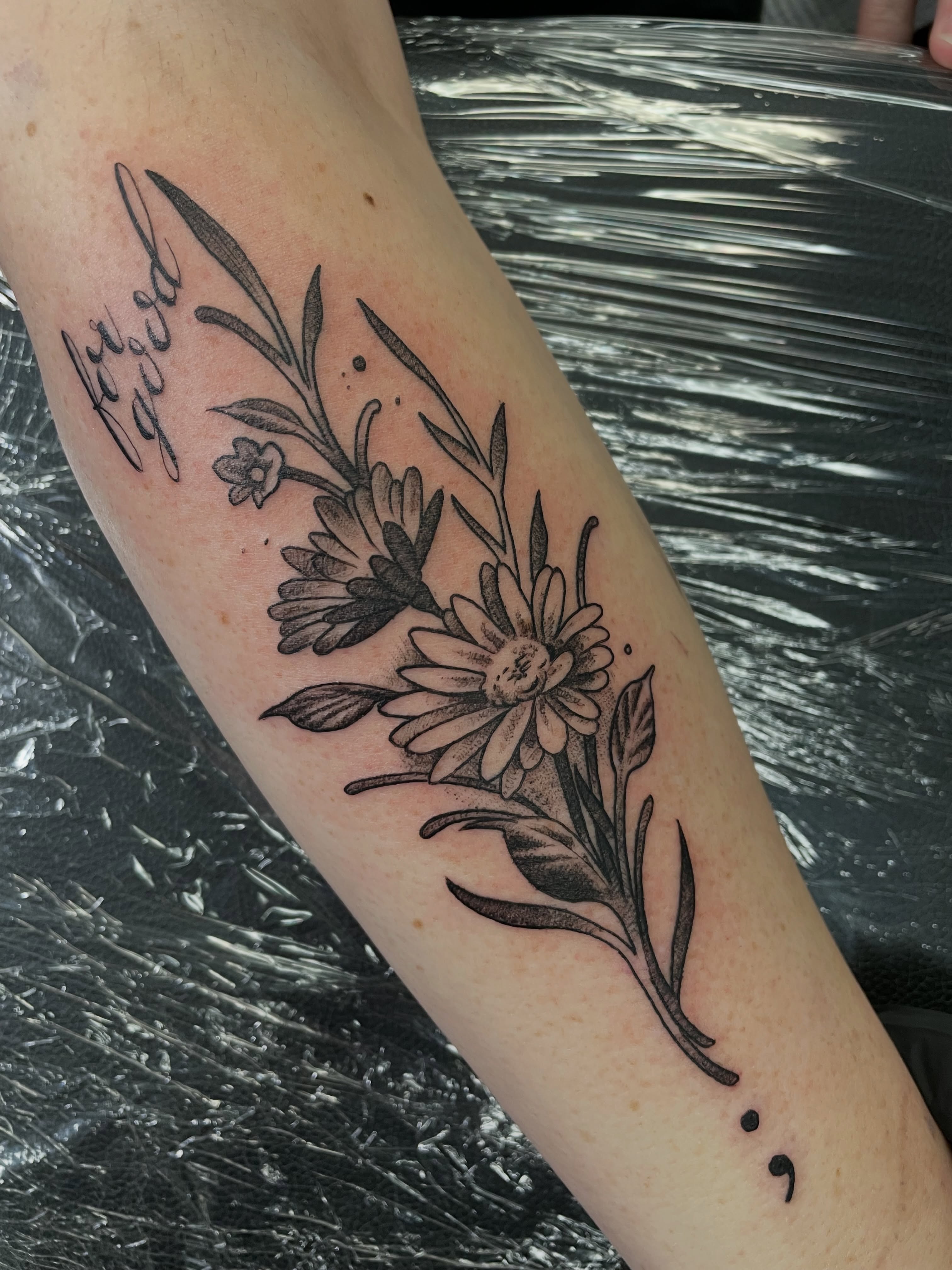 Floral arrangement black and grey tattoo on the forearm by Steven Hodges